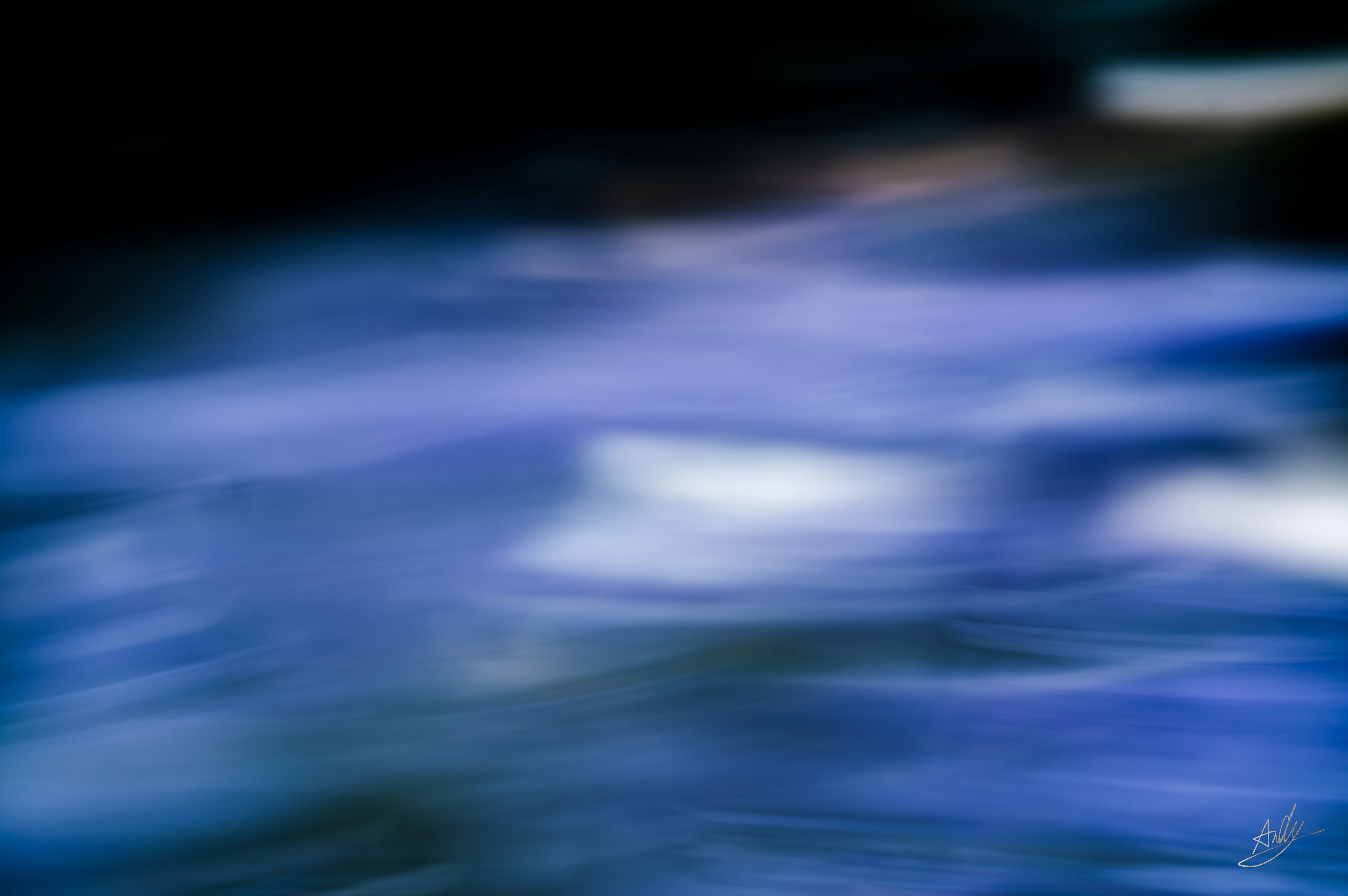 Blurred image of flowing blue water