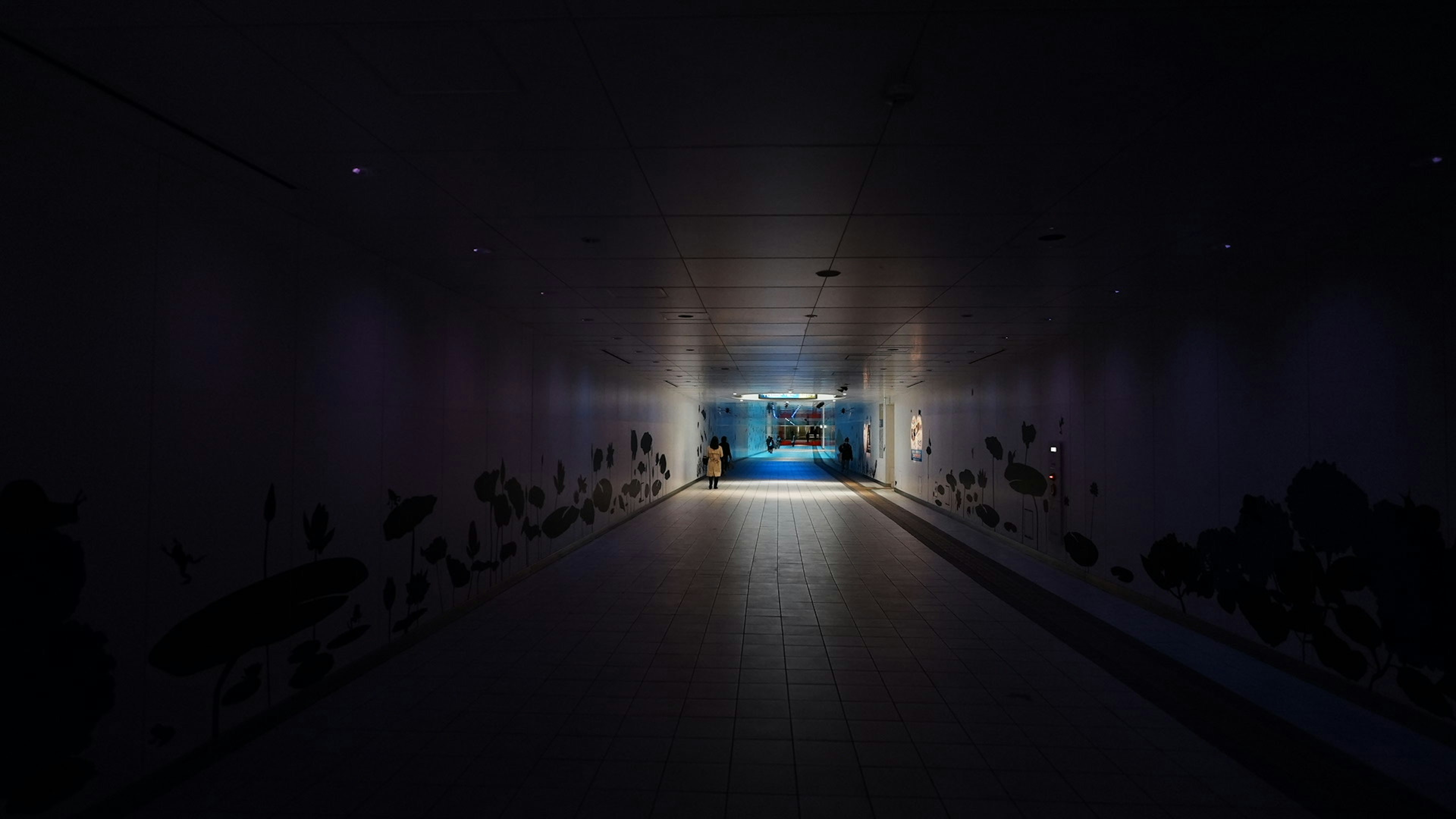 Dark tunnel with blue light at the end