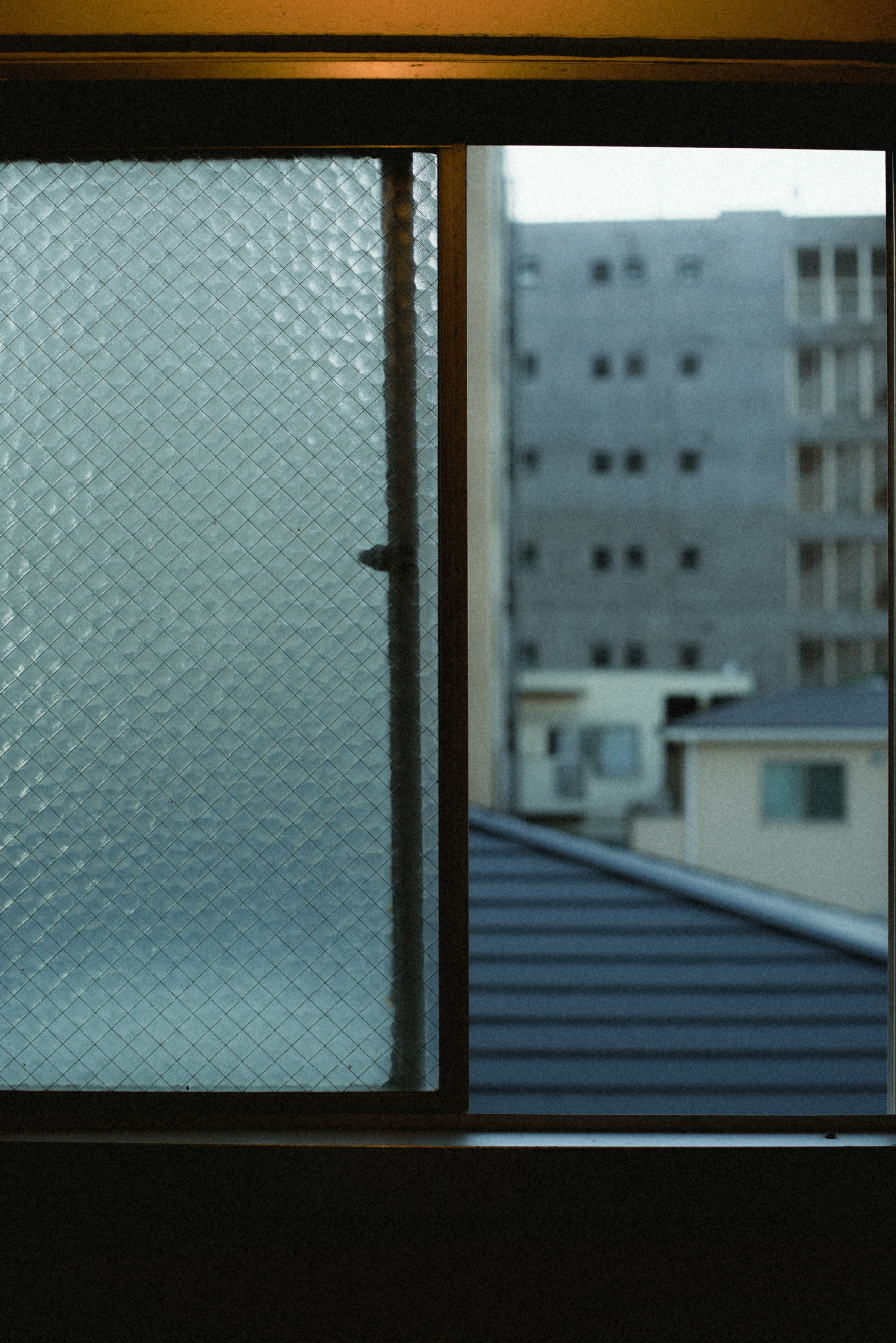 Urban view through a textured glass window