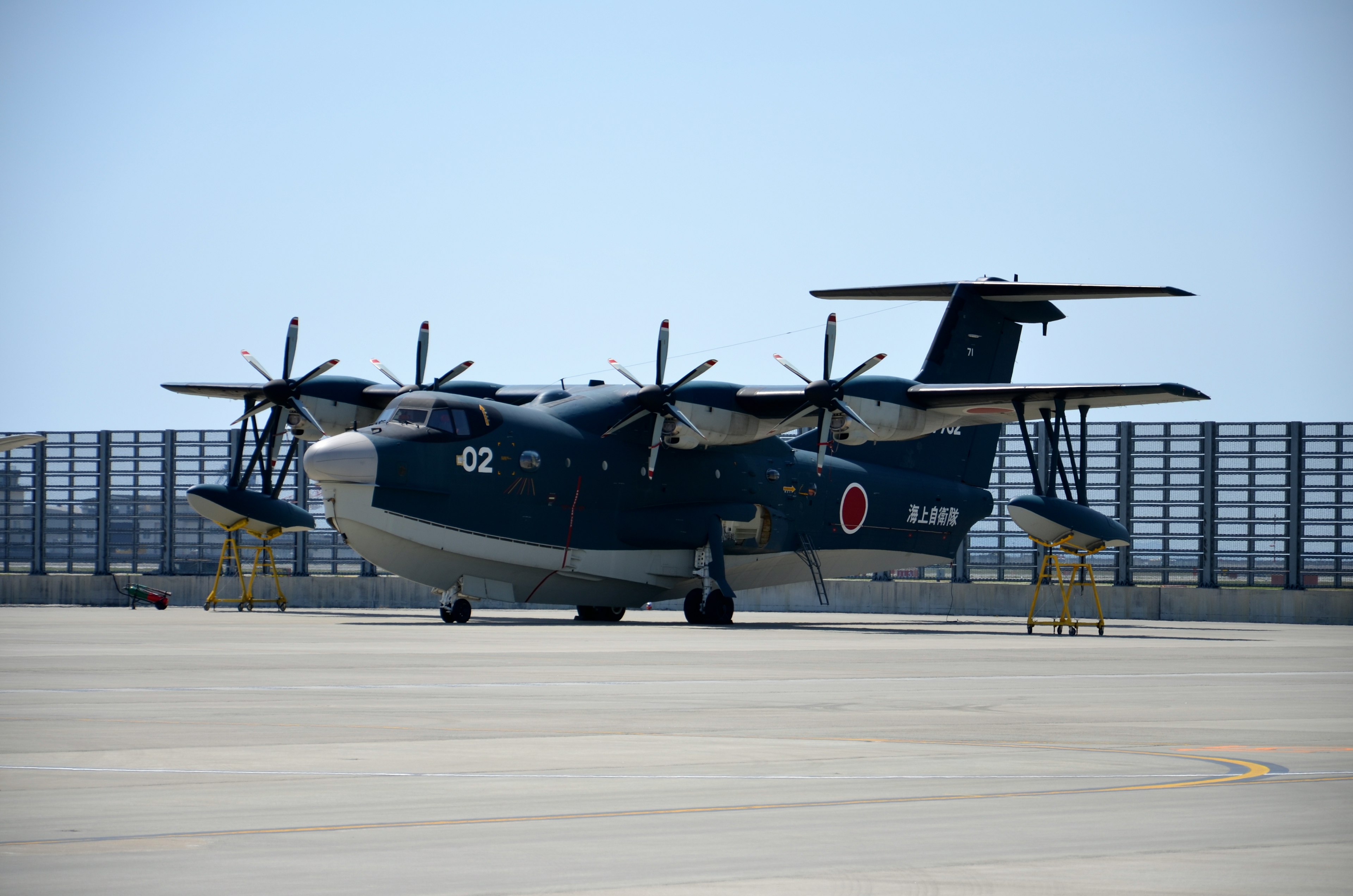 A blue-painted aircraft with Japanese flag markings on the side