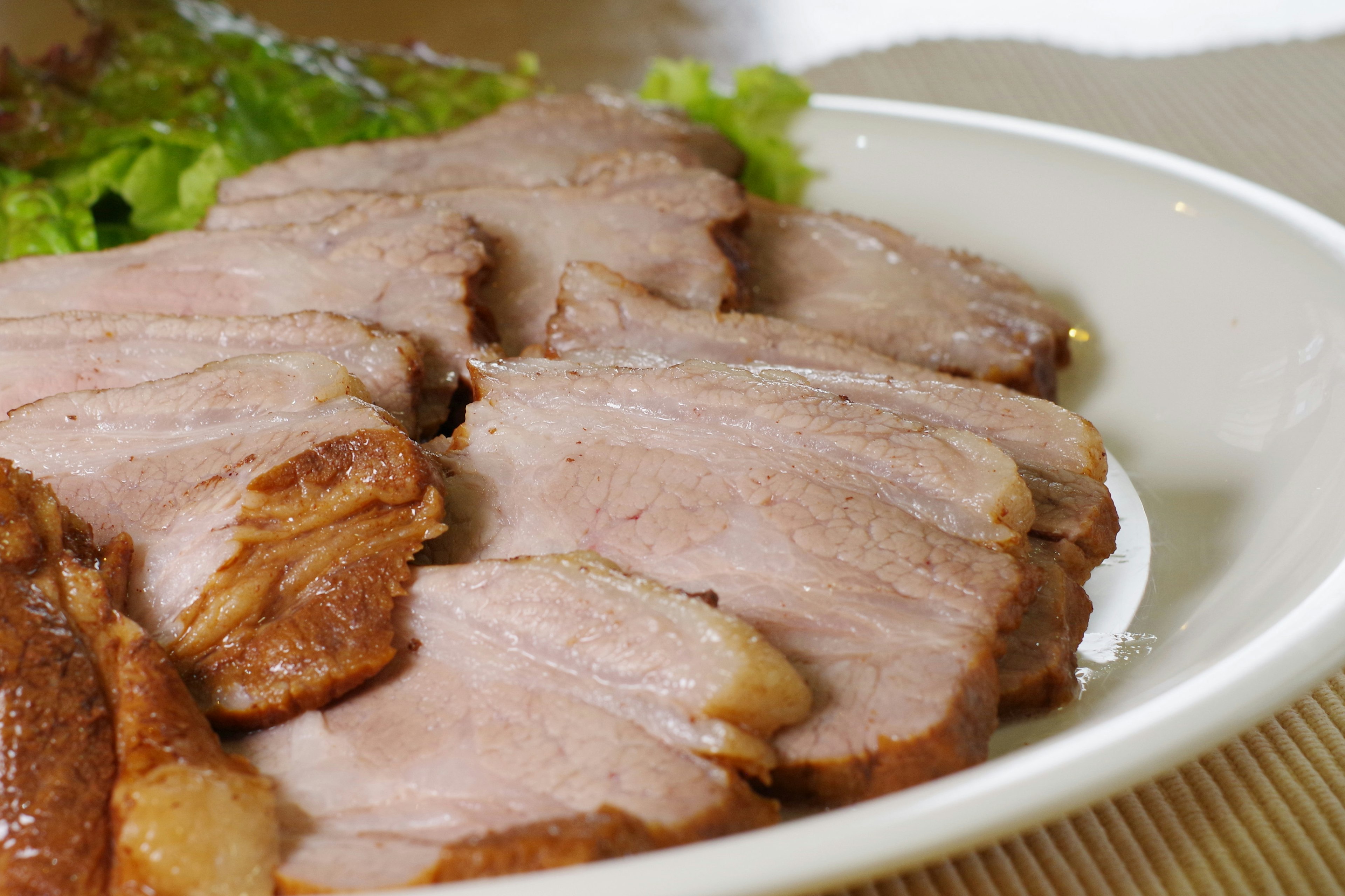 Sliced meat beautifully arranged on a plate