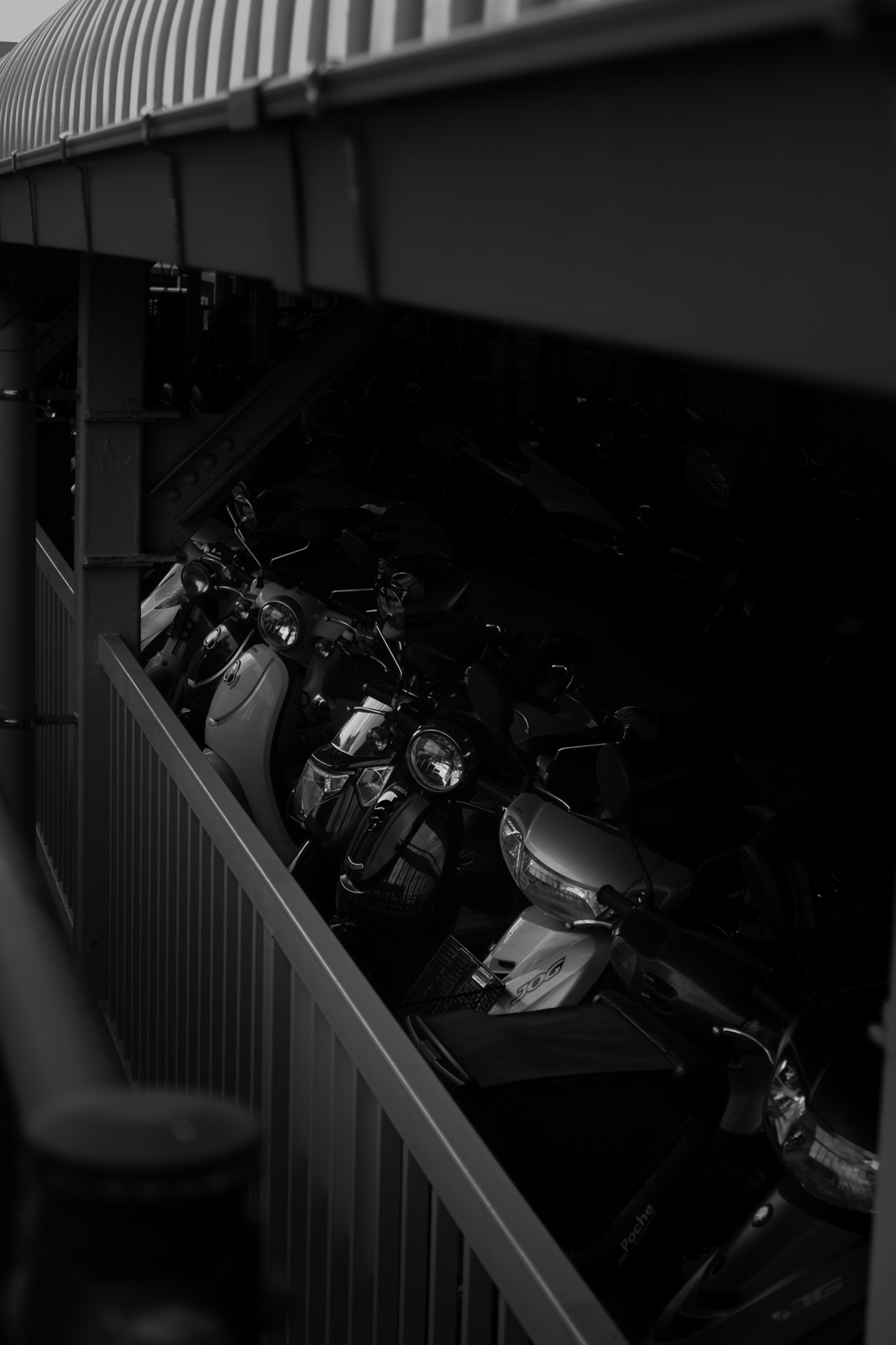 Photo showing multiple motorcycles parked in a dark area