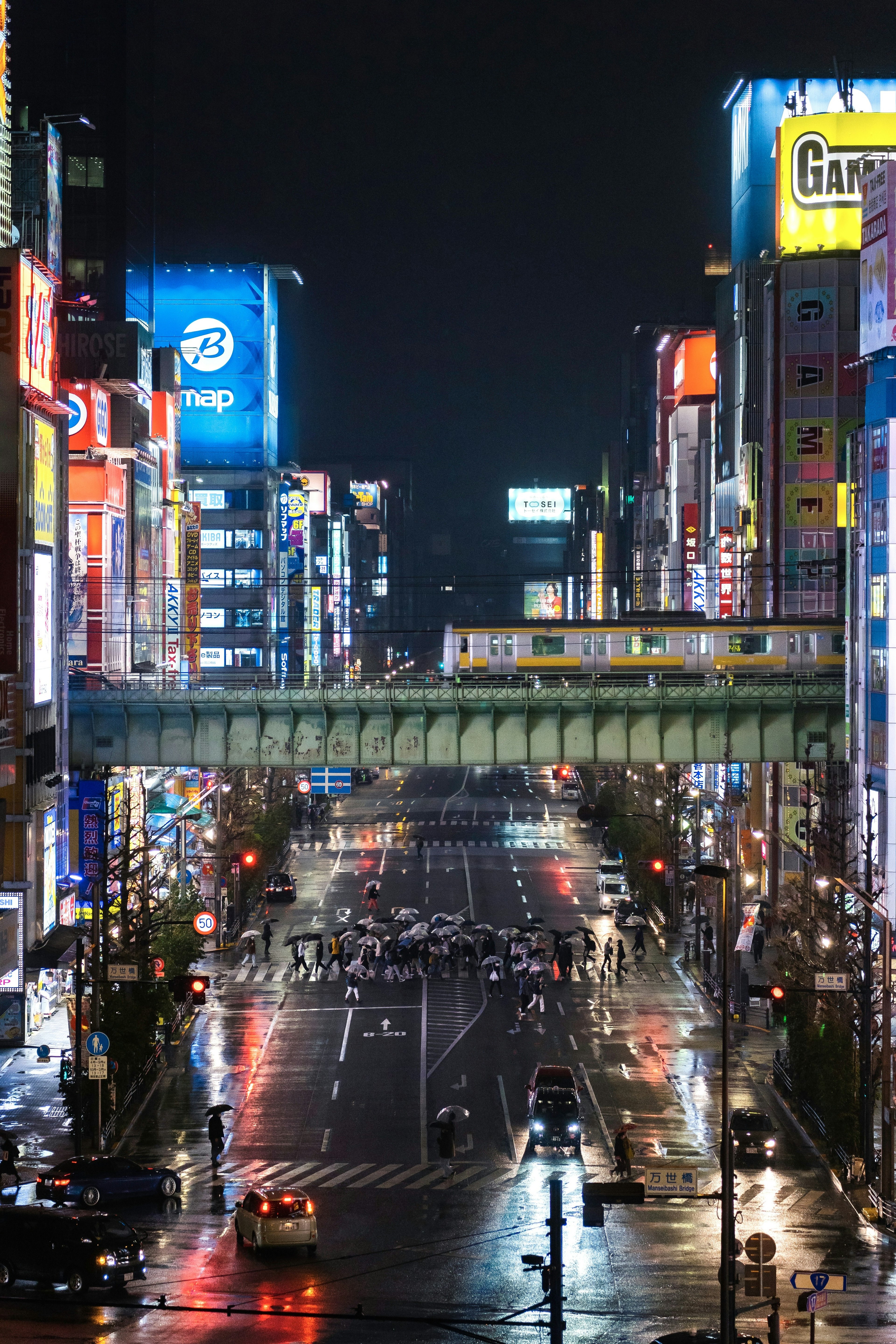 A bustling city street at night with neon signs and bright lights