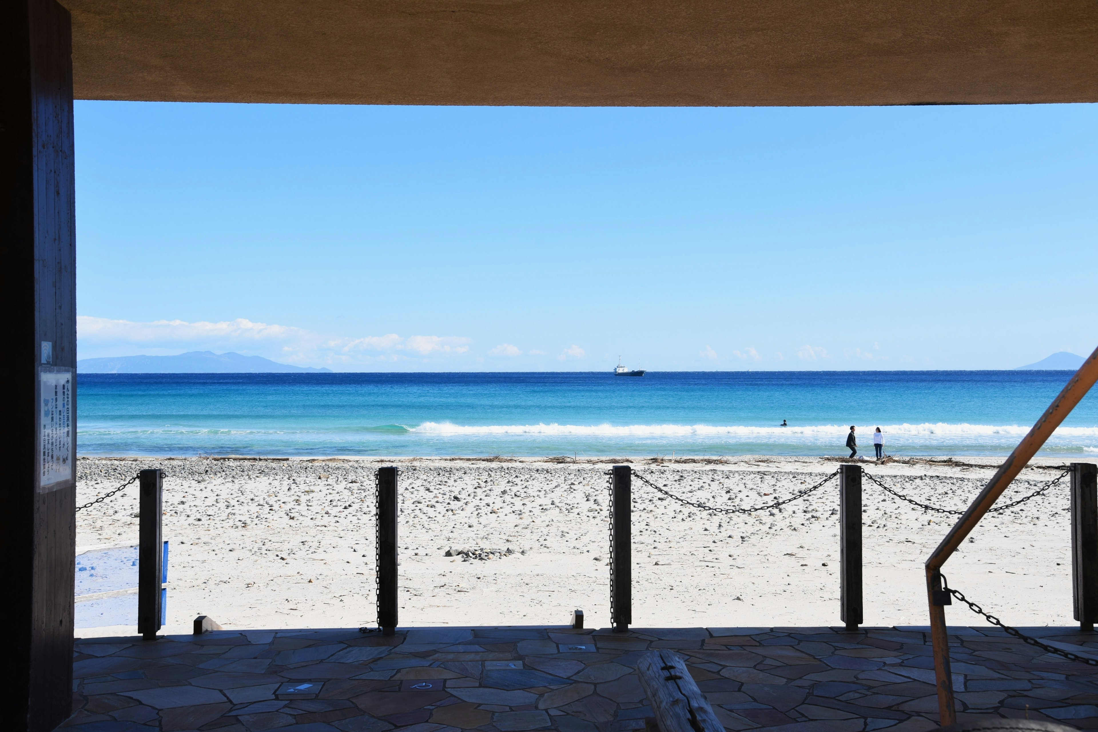 View of a beach with blue ocean and sandy shore