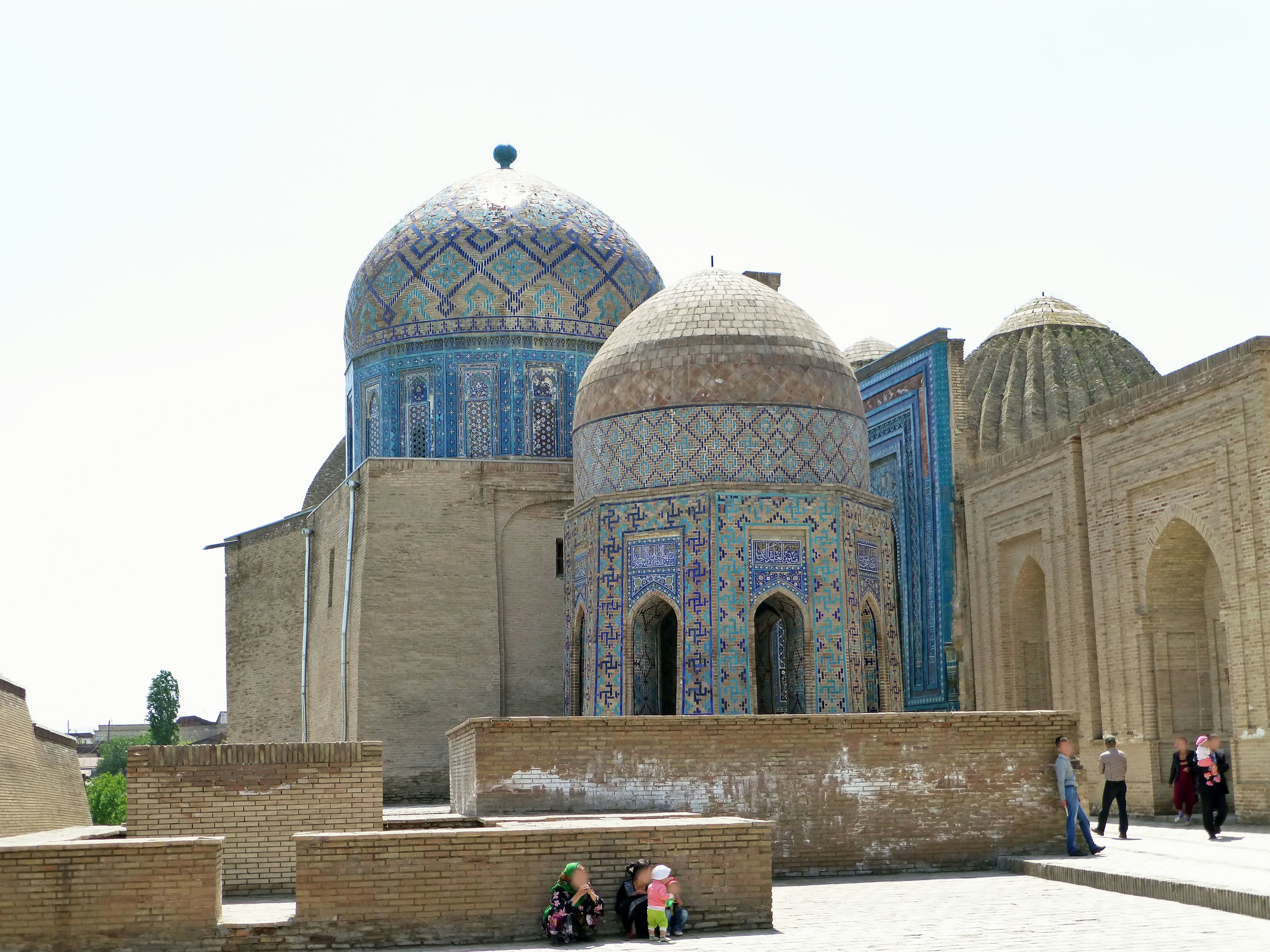 Historic building with blue domes and people