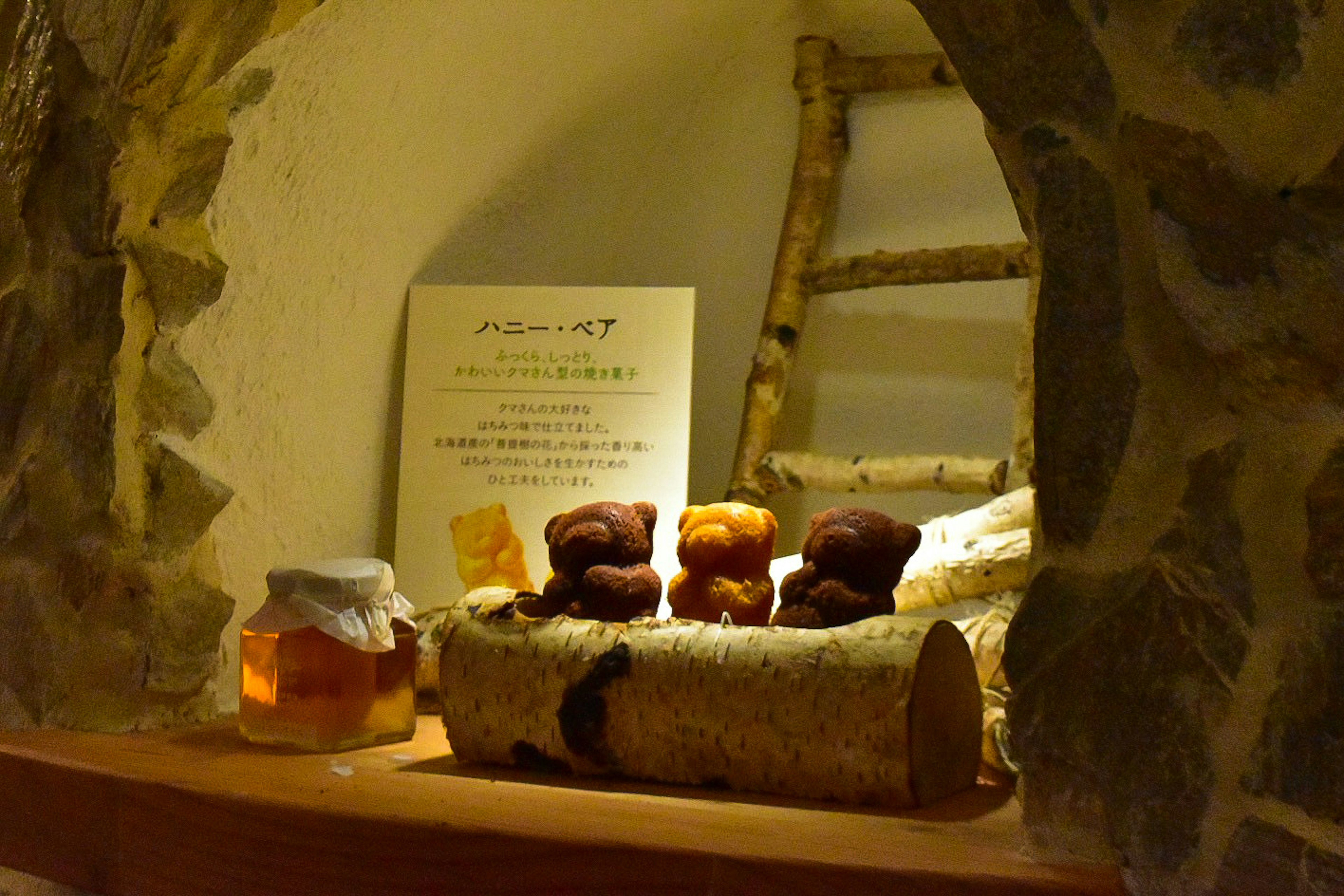 Intérieur chaleureux avec des pâtisseries sur un présentoir en bois et un pot de miel