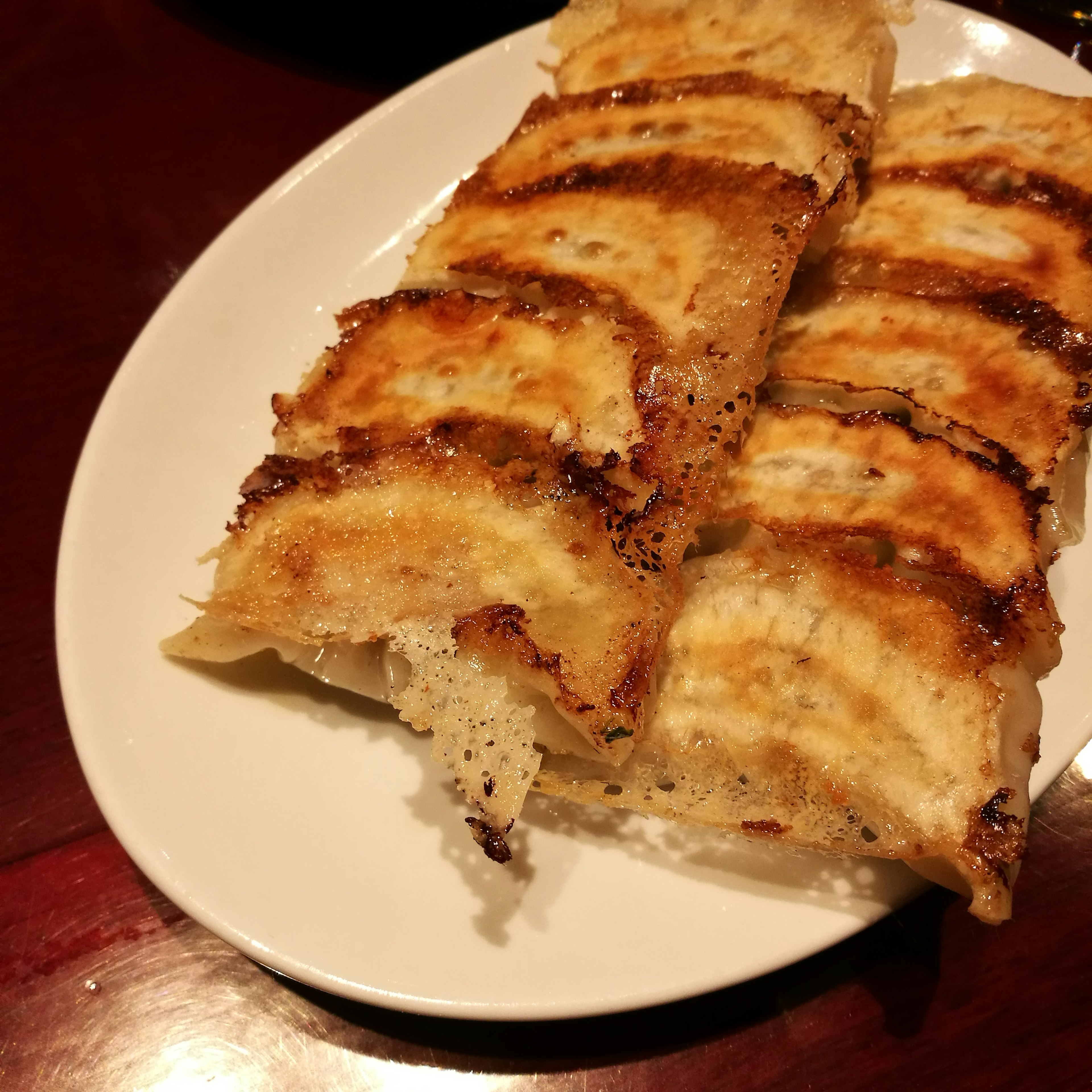 Plate of grilled gyoza with golden brown crust