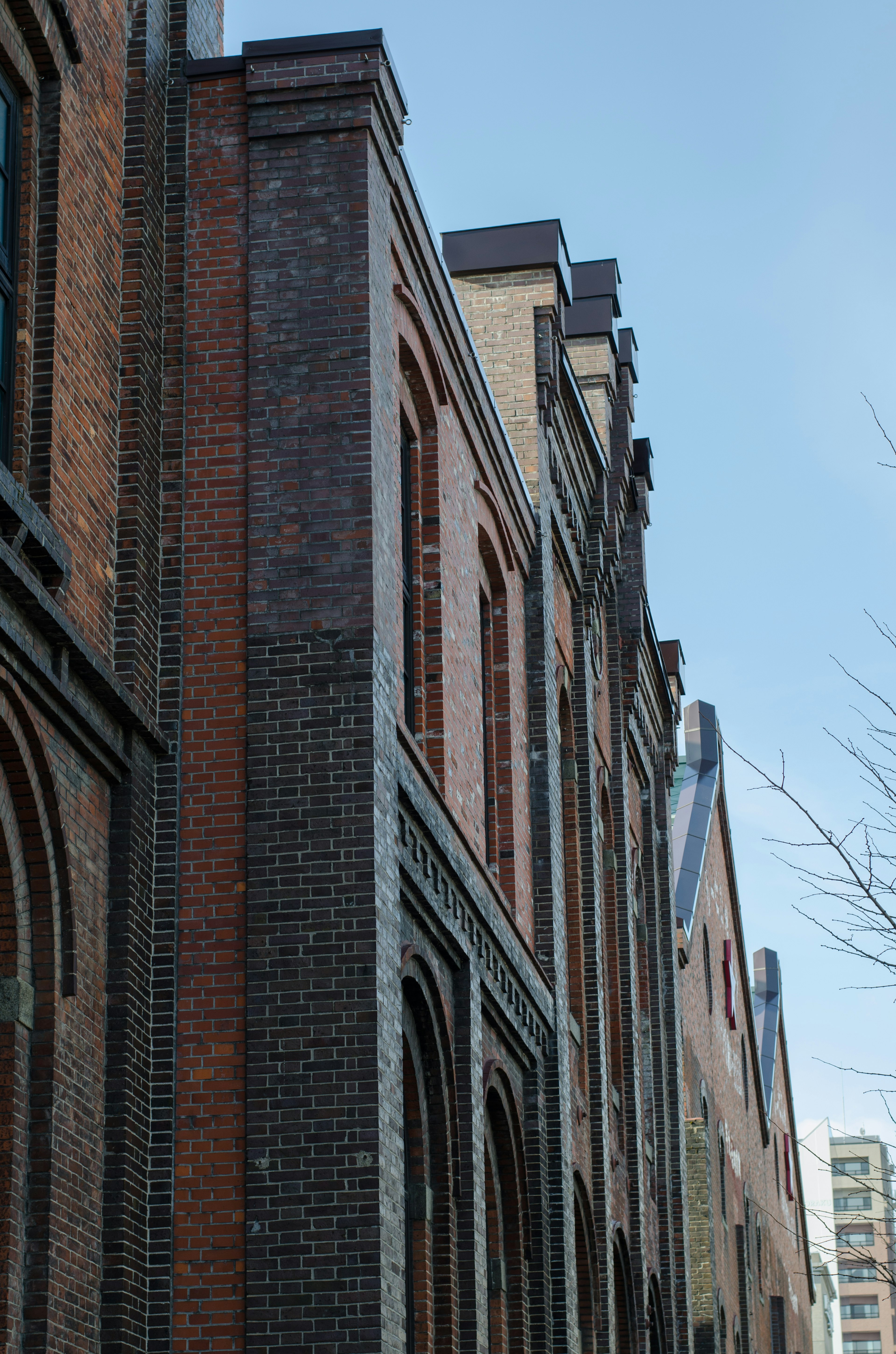 Side view of a brick building with a clear blue sky in the background