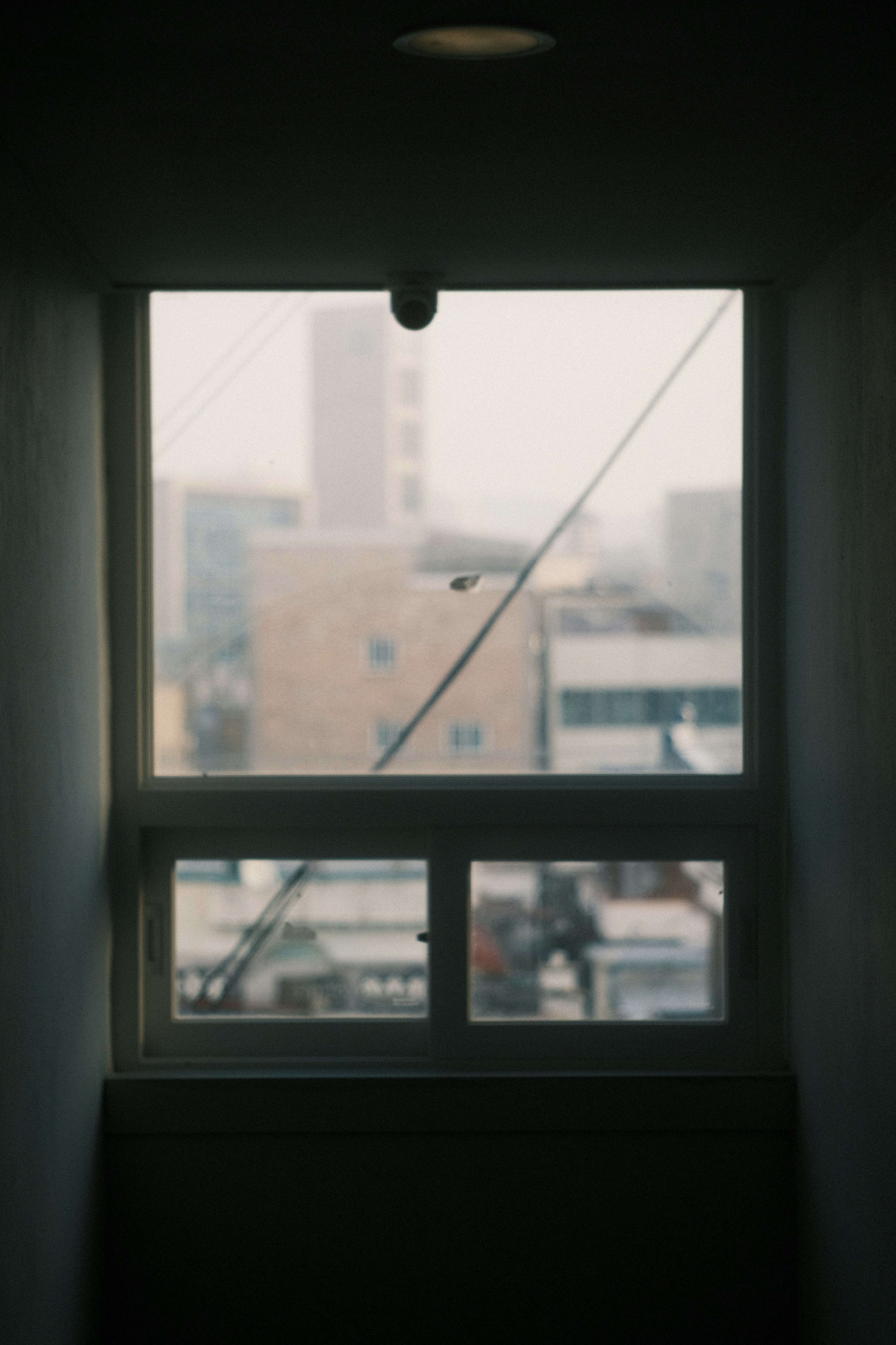 View of a cityscape through a foggy window with buildings