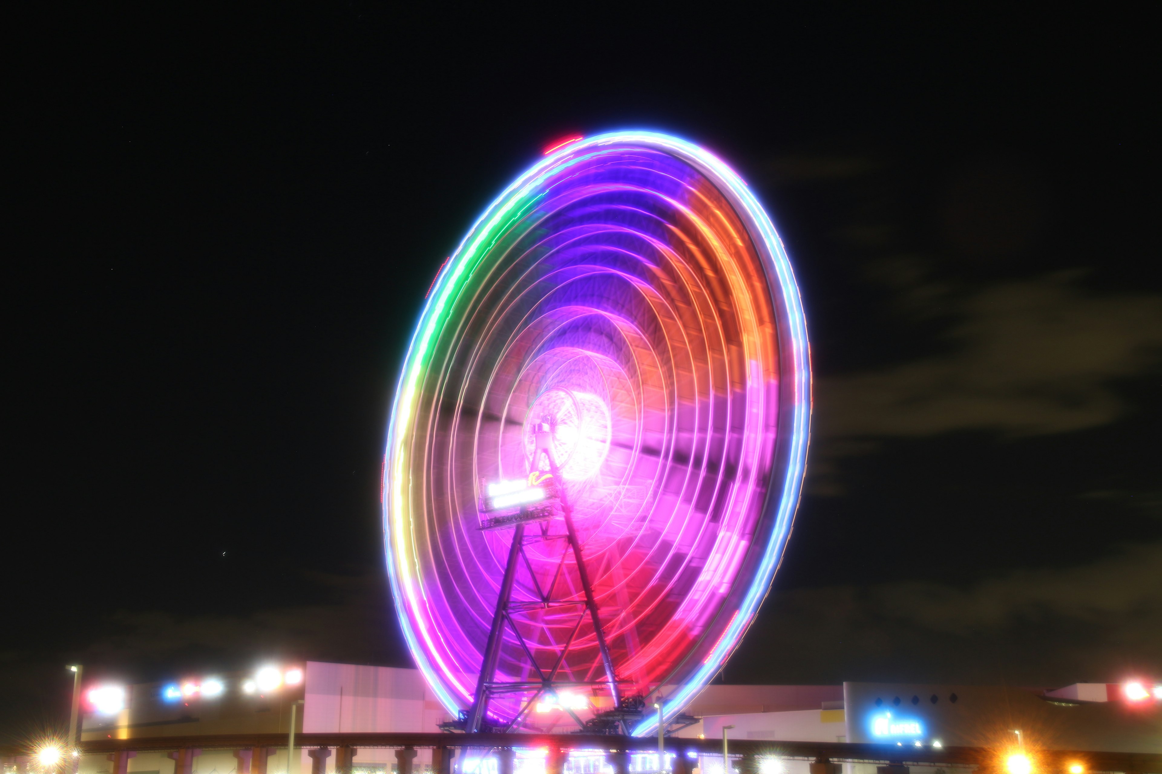 Colorful Ferris wheel illuminated at night