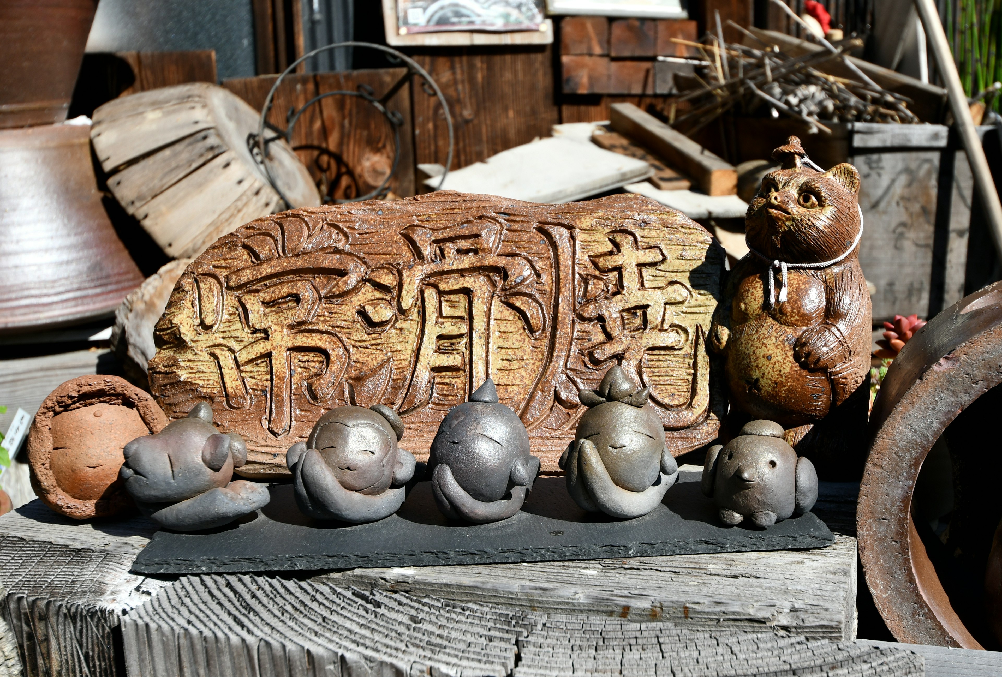 A display of ceramic animal figures alongside a wooden sign