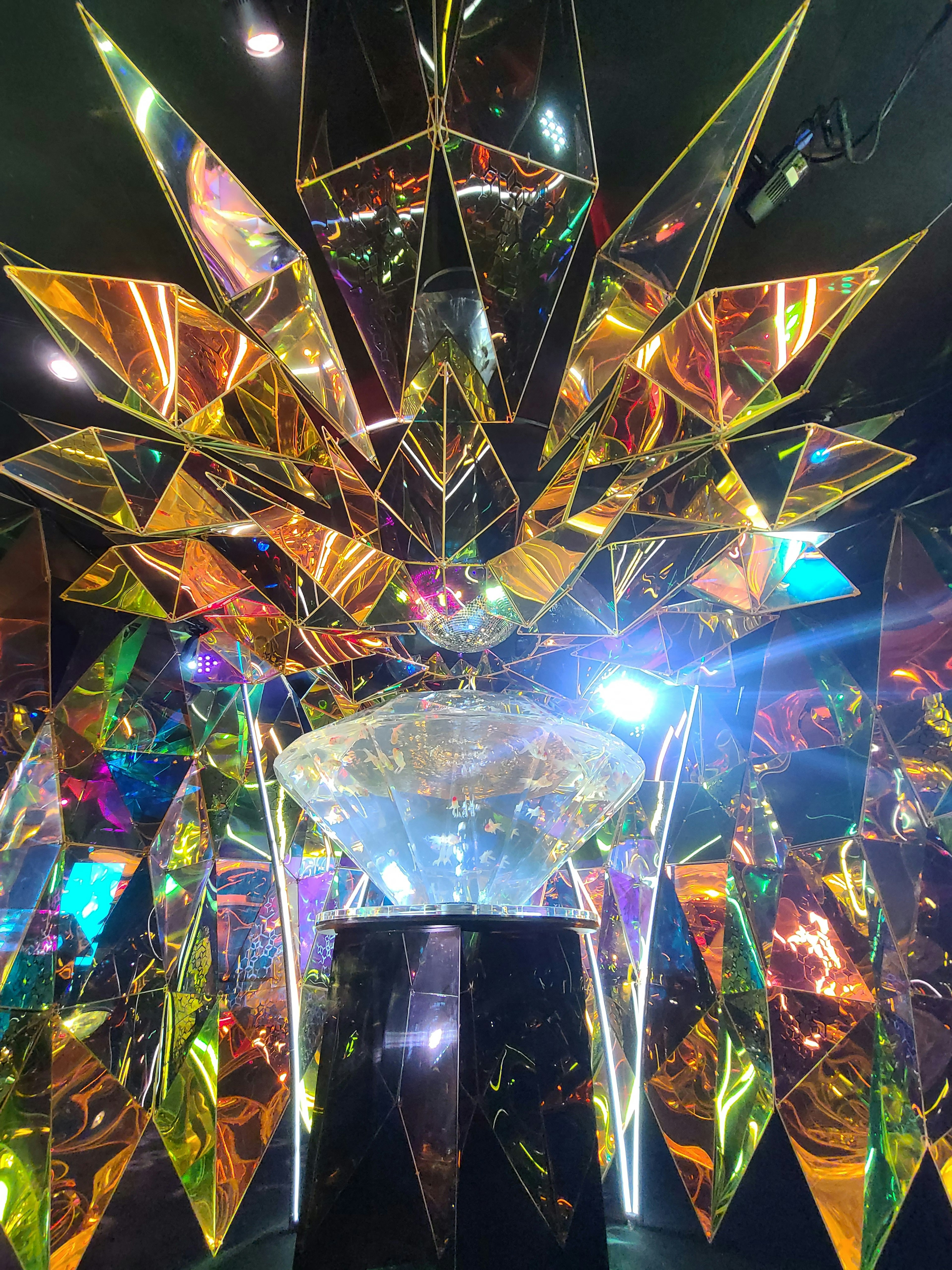 Colorful reflective prism art installation with vibrant lights