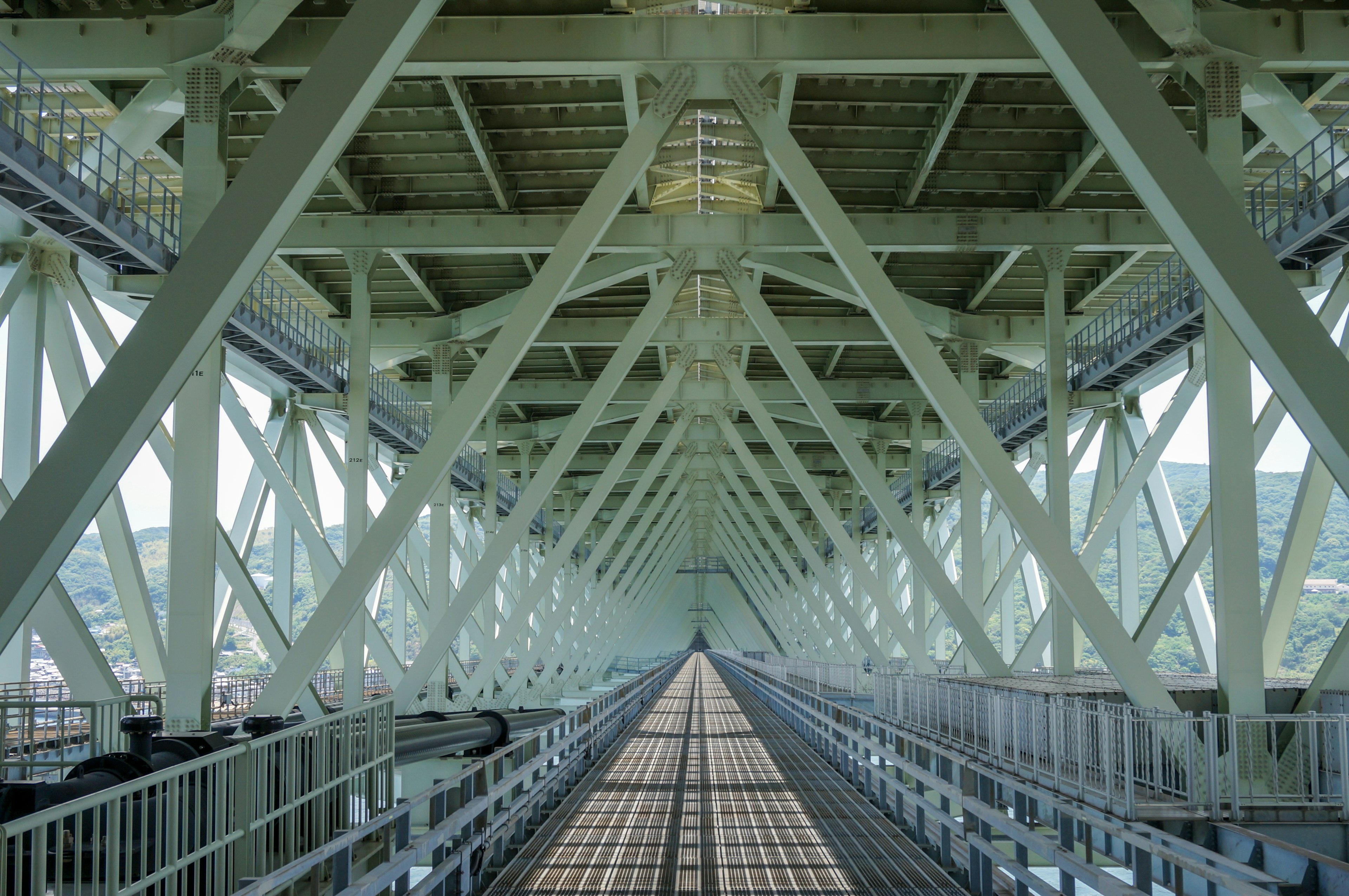 View of the underside of a bridge with intersecting steel beams