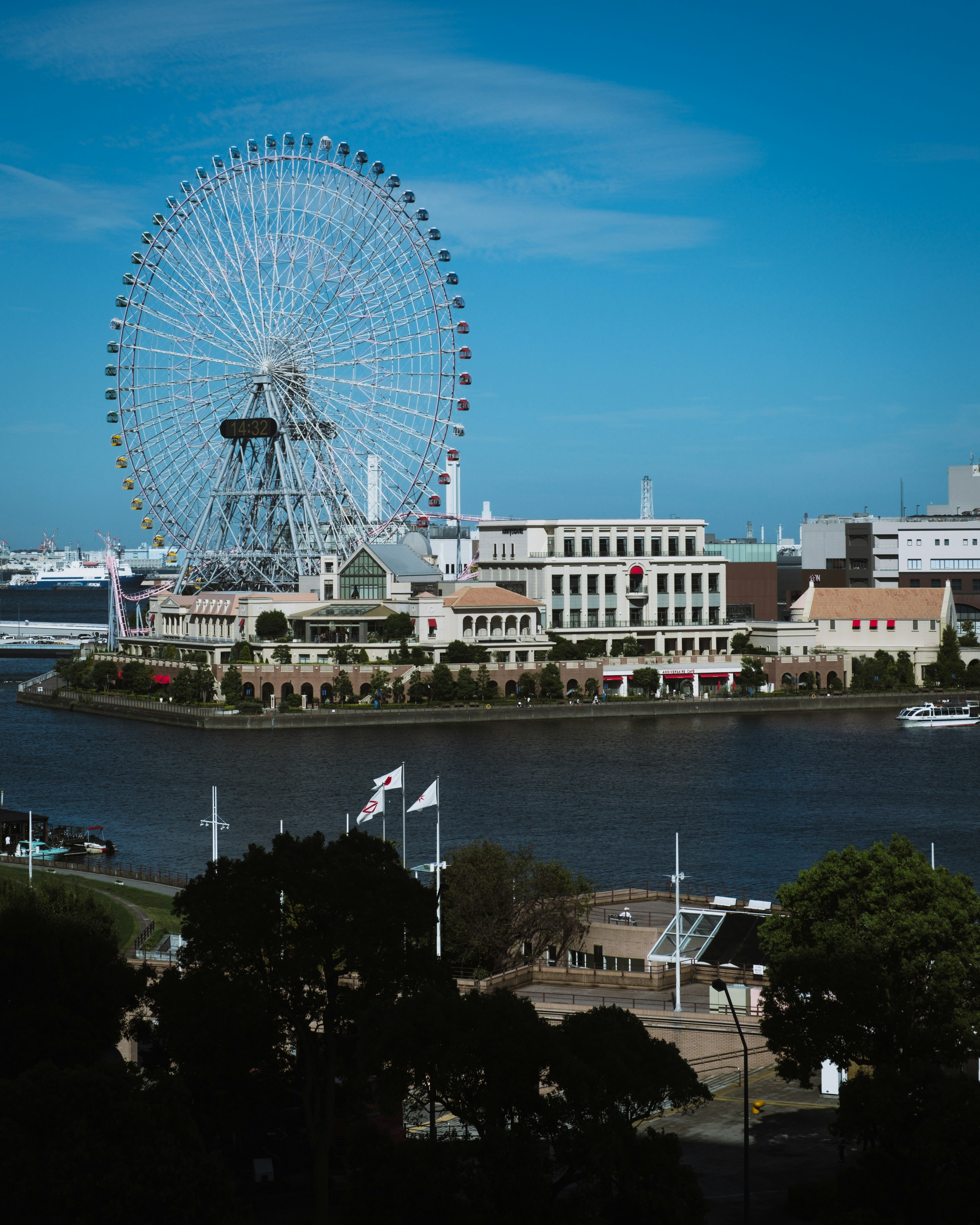 Urban landscape featuring a Ferris wheel and a river