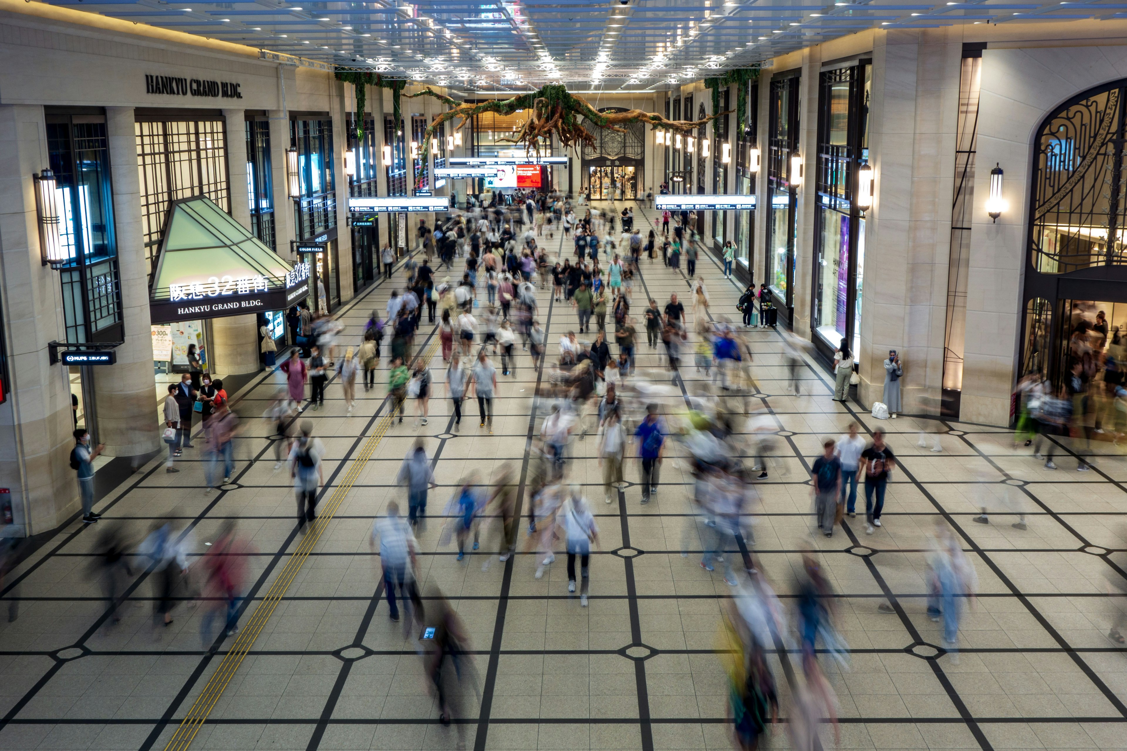 Busy interior of a shopping mall with people walking