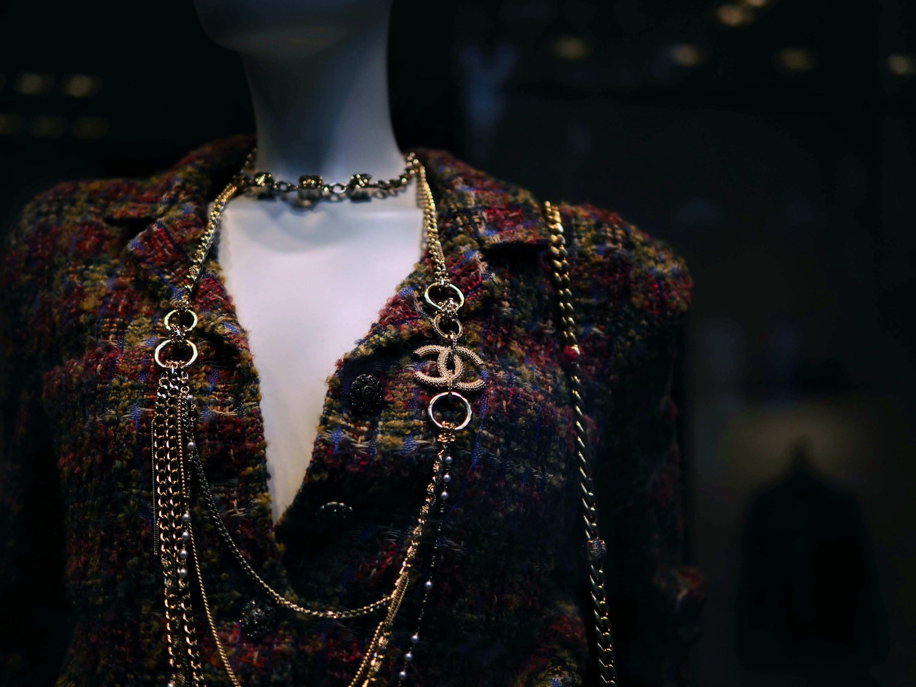 Display of clothing featuring a choker and gold chains