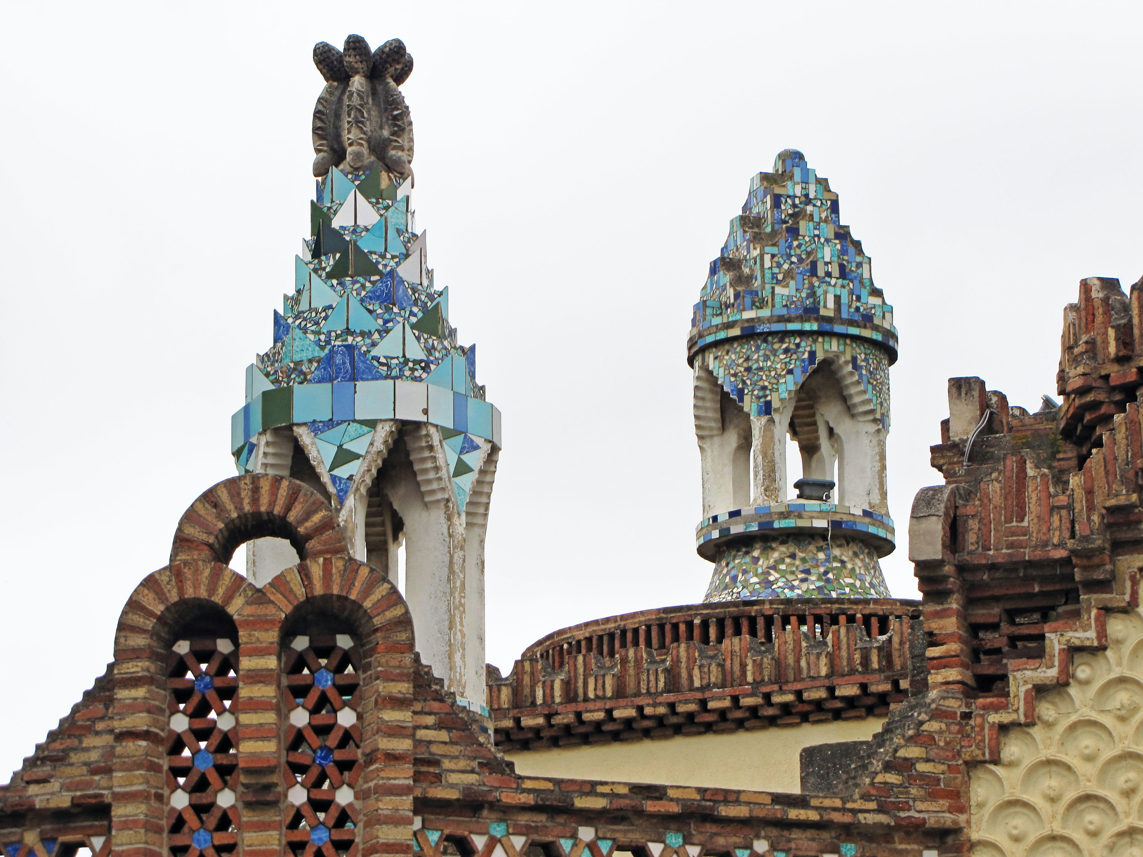 Unique roof spires adorned with mosaic tiles and sculpted details