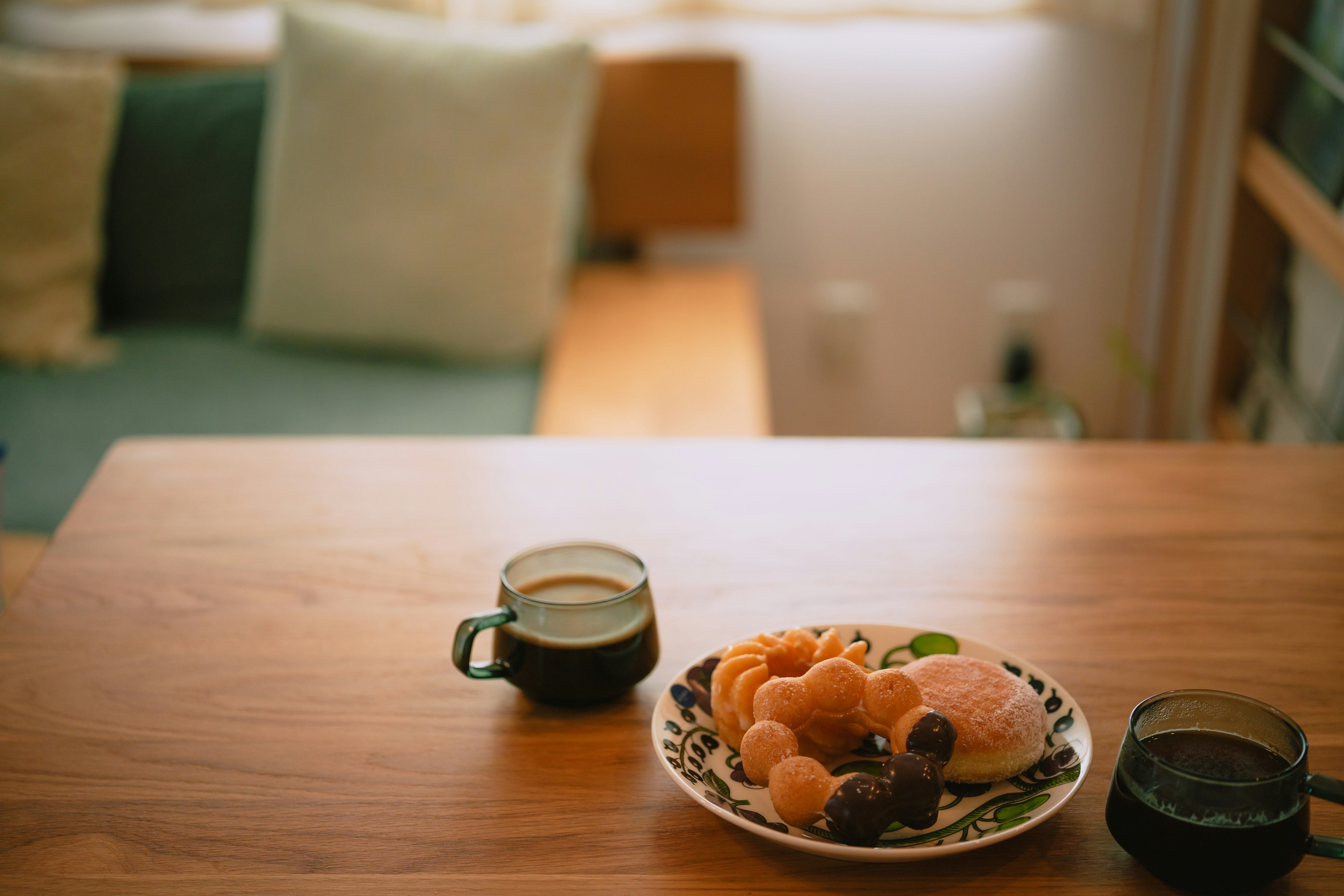 การตั้งโต๊ะที่สะดวกสบายพร้อมกาแฟและจานขนมอบแสงธรรมชาติส่องเข้ามา