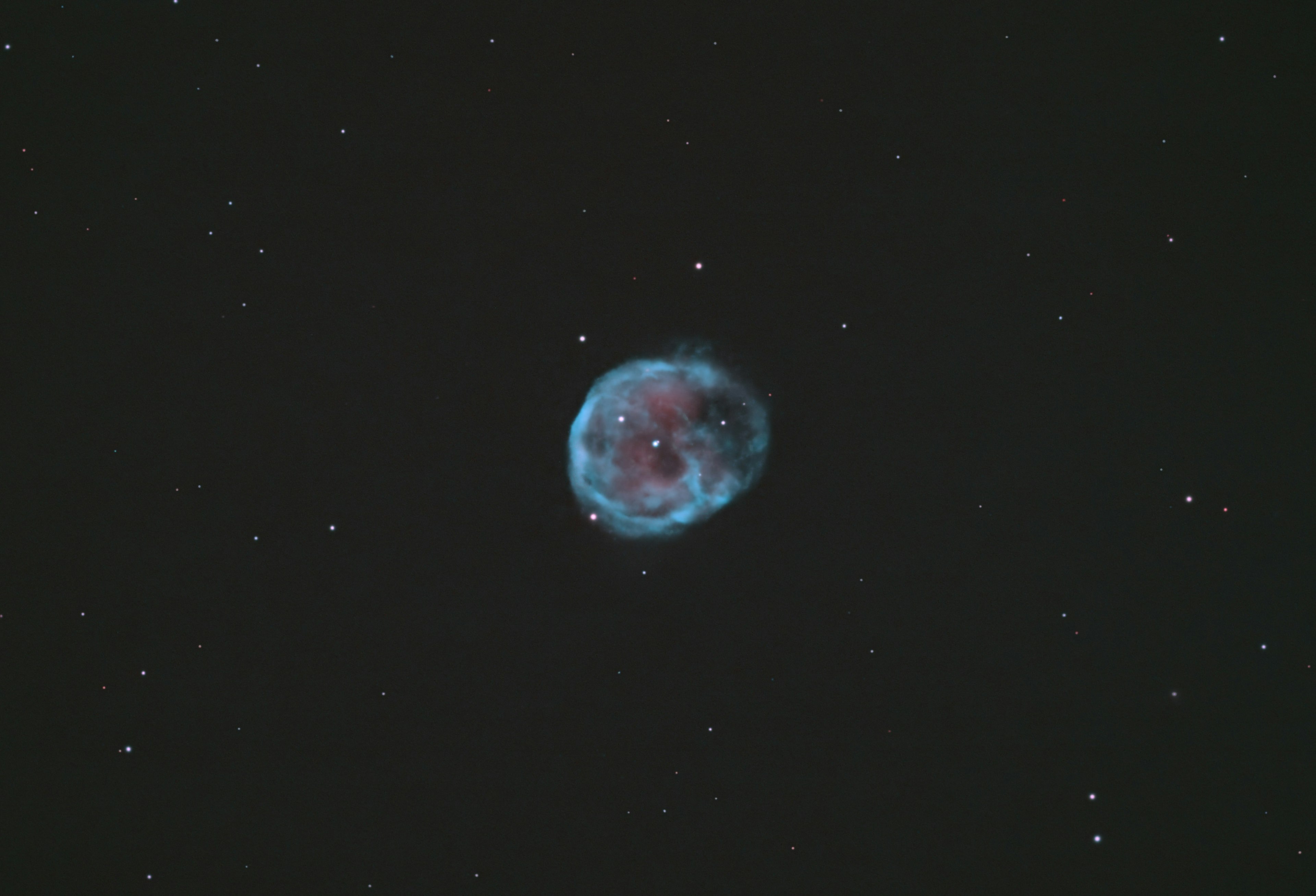 A glowing blue nebula surrounded by stars in a dark sky