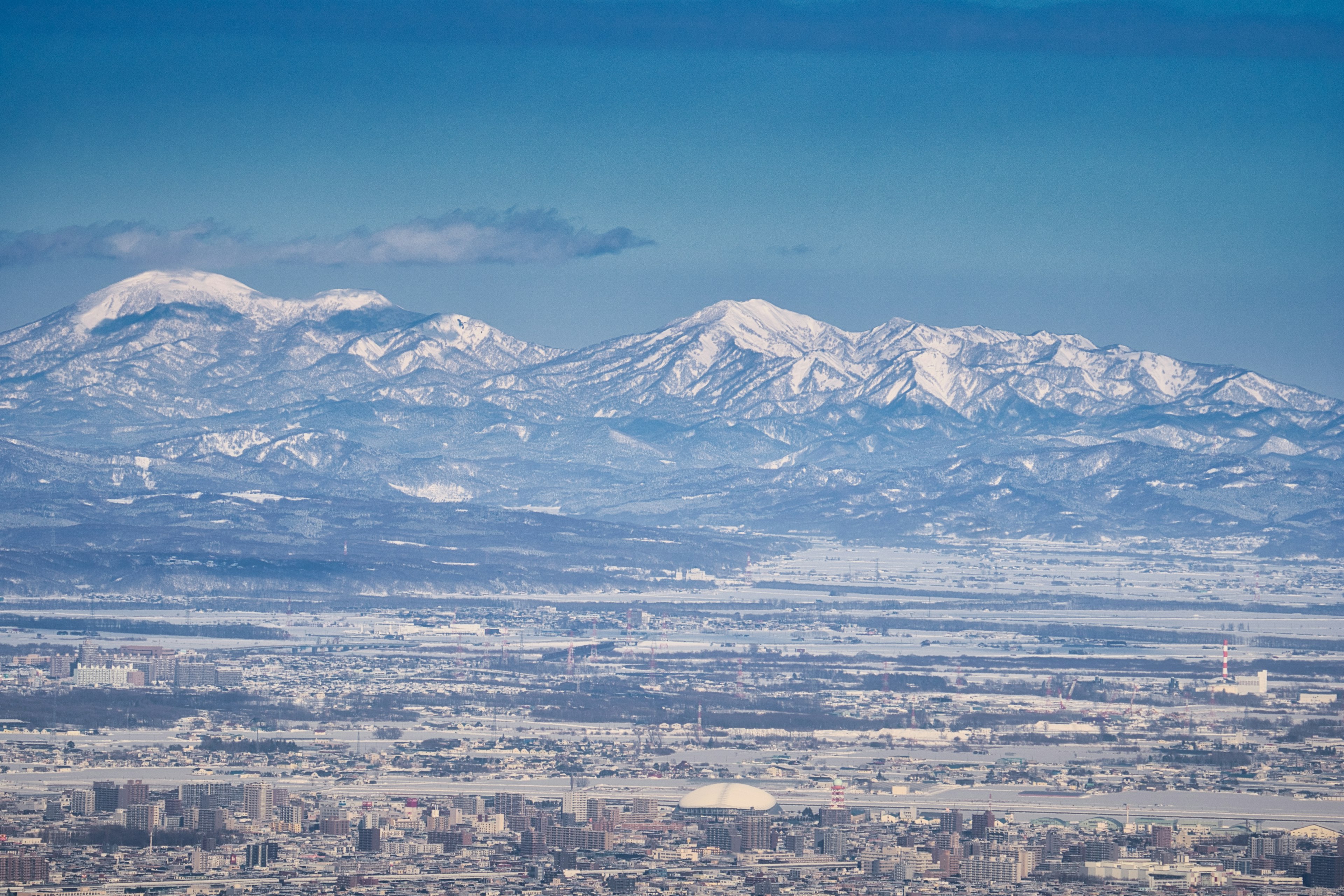 Snow-covered mountains under a clear blue sky