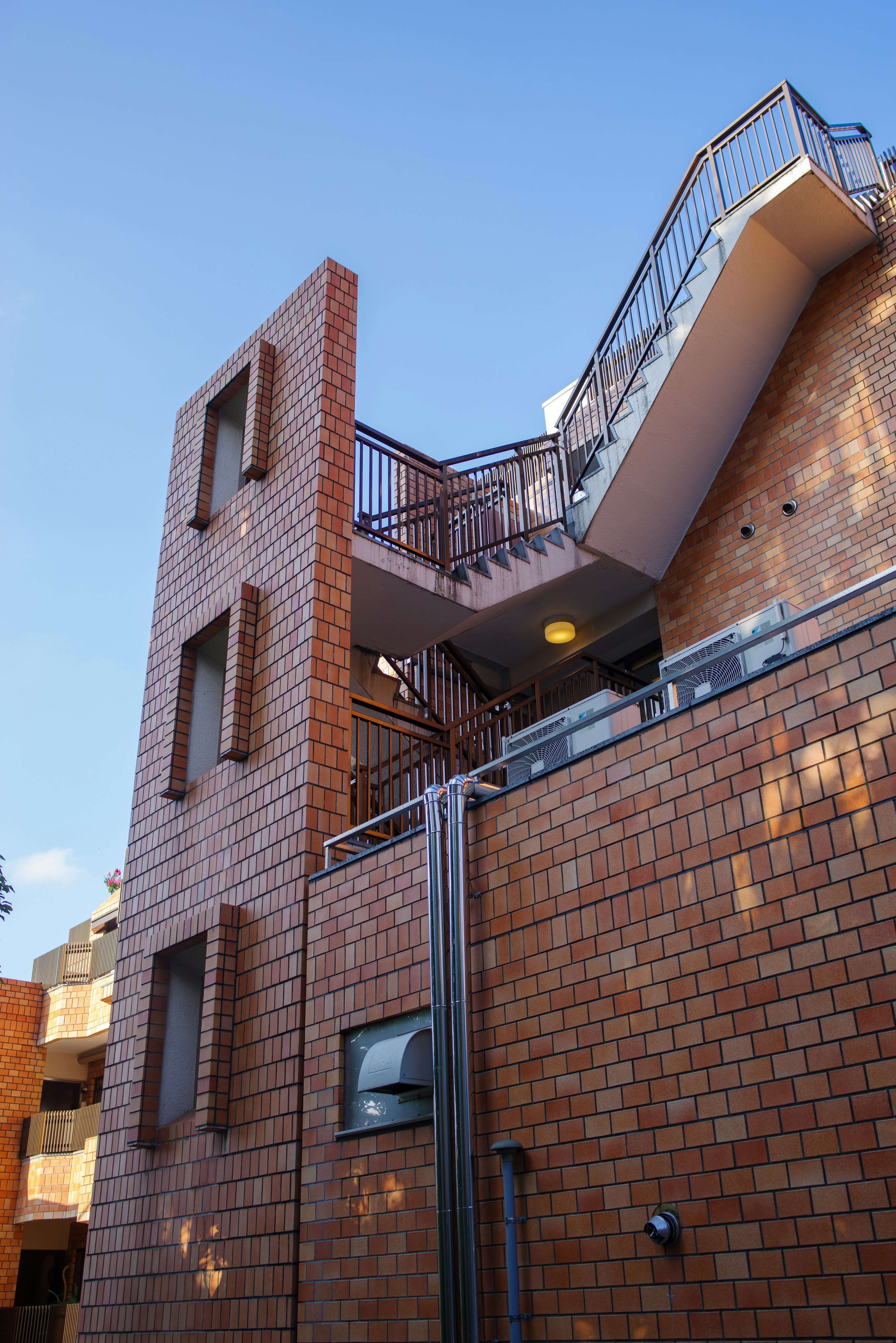 Bâtiment en briques rouges avec design d'escalier en métal