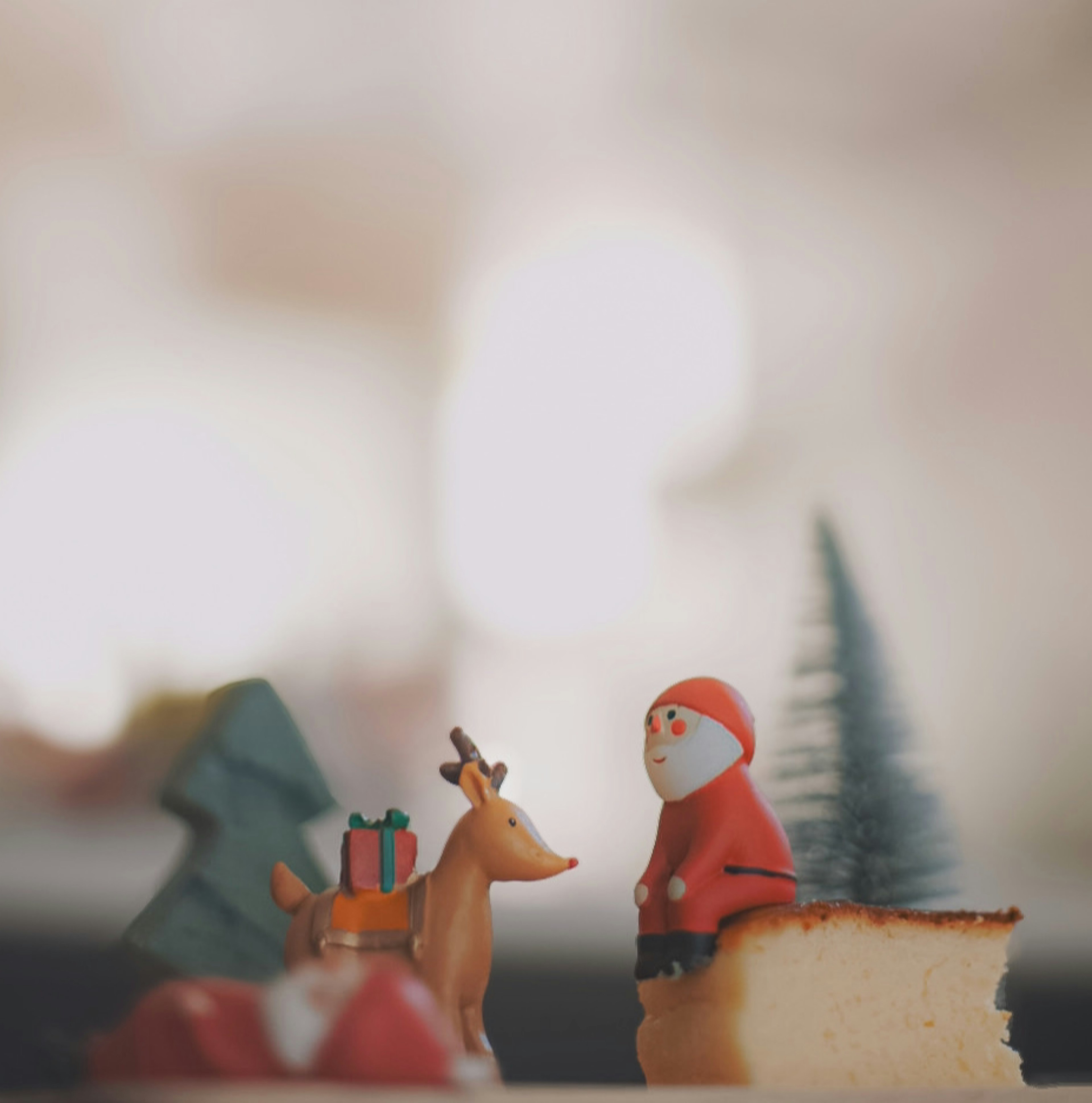 Christmas decorations featuring Santa figurine and reindeer on a dessert