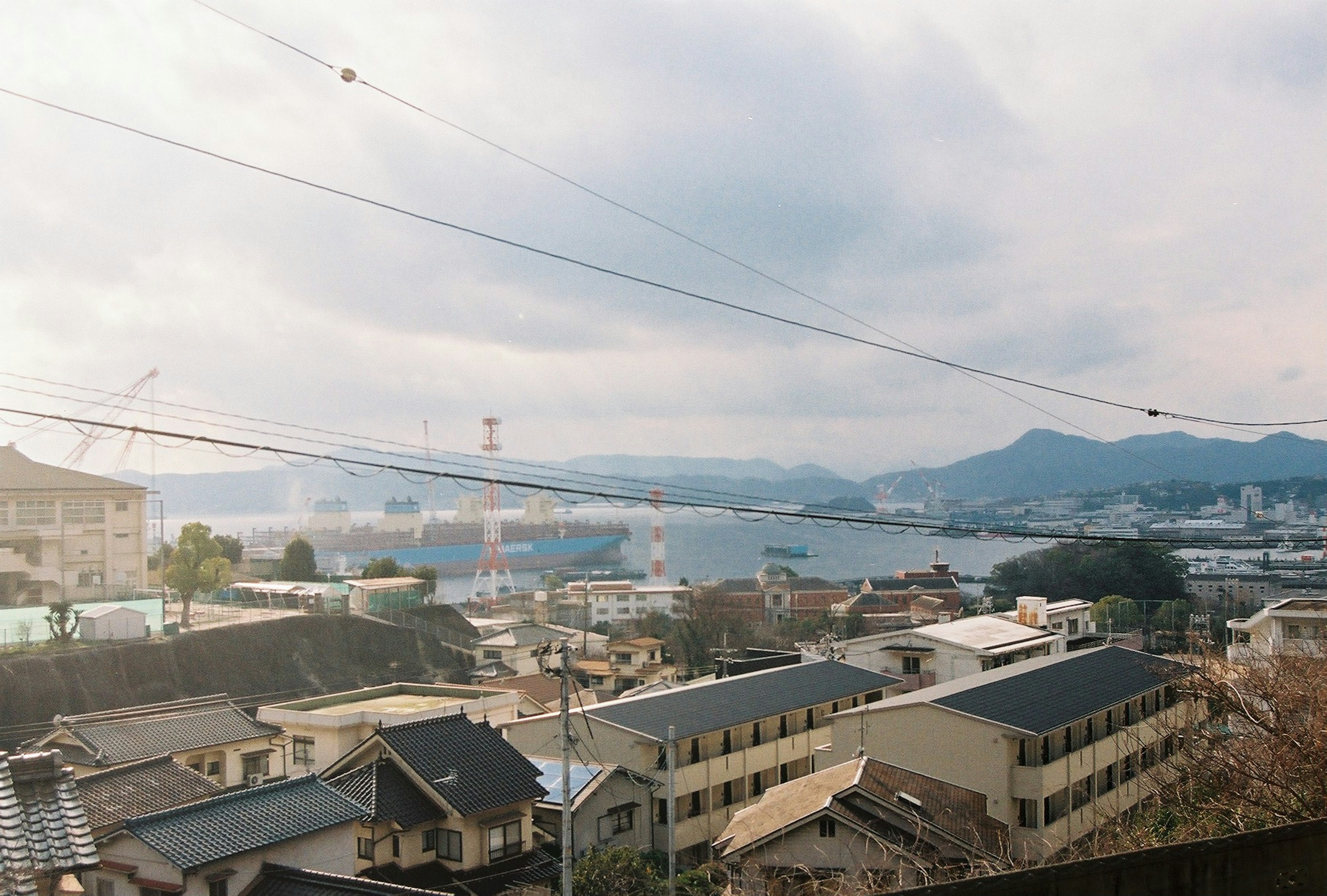 Cityscape featuring a view of the sea and mountains