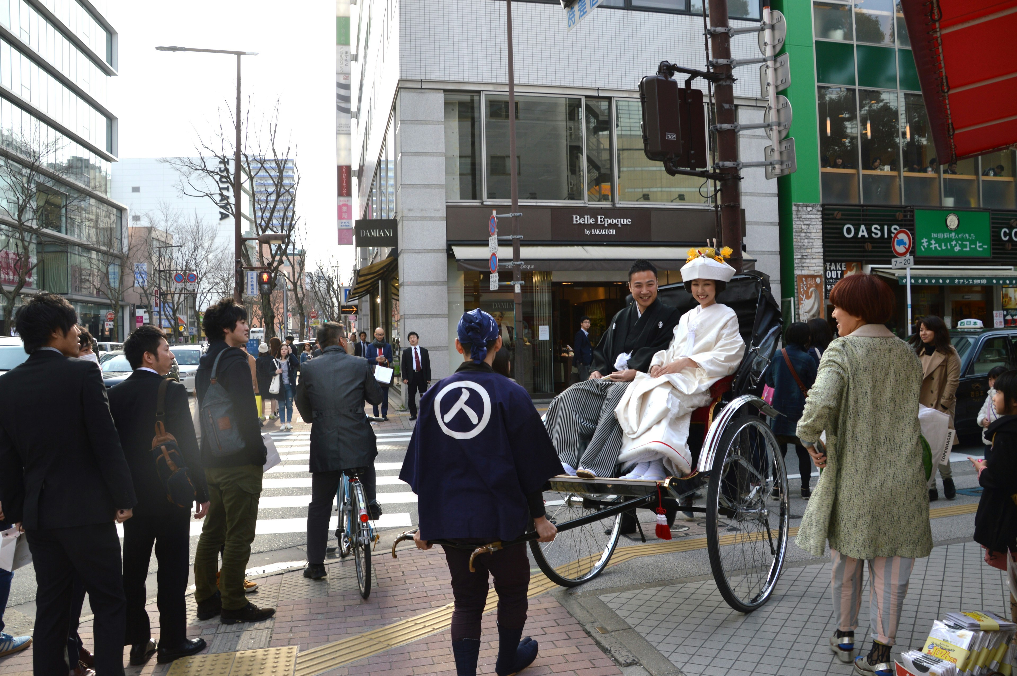 A person in a rickshaw attracting attention in a city street