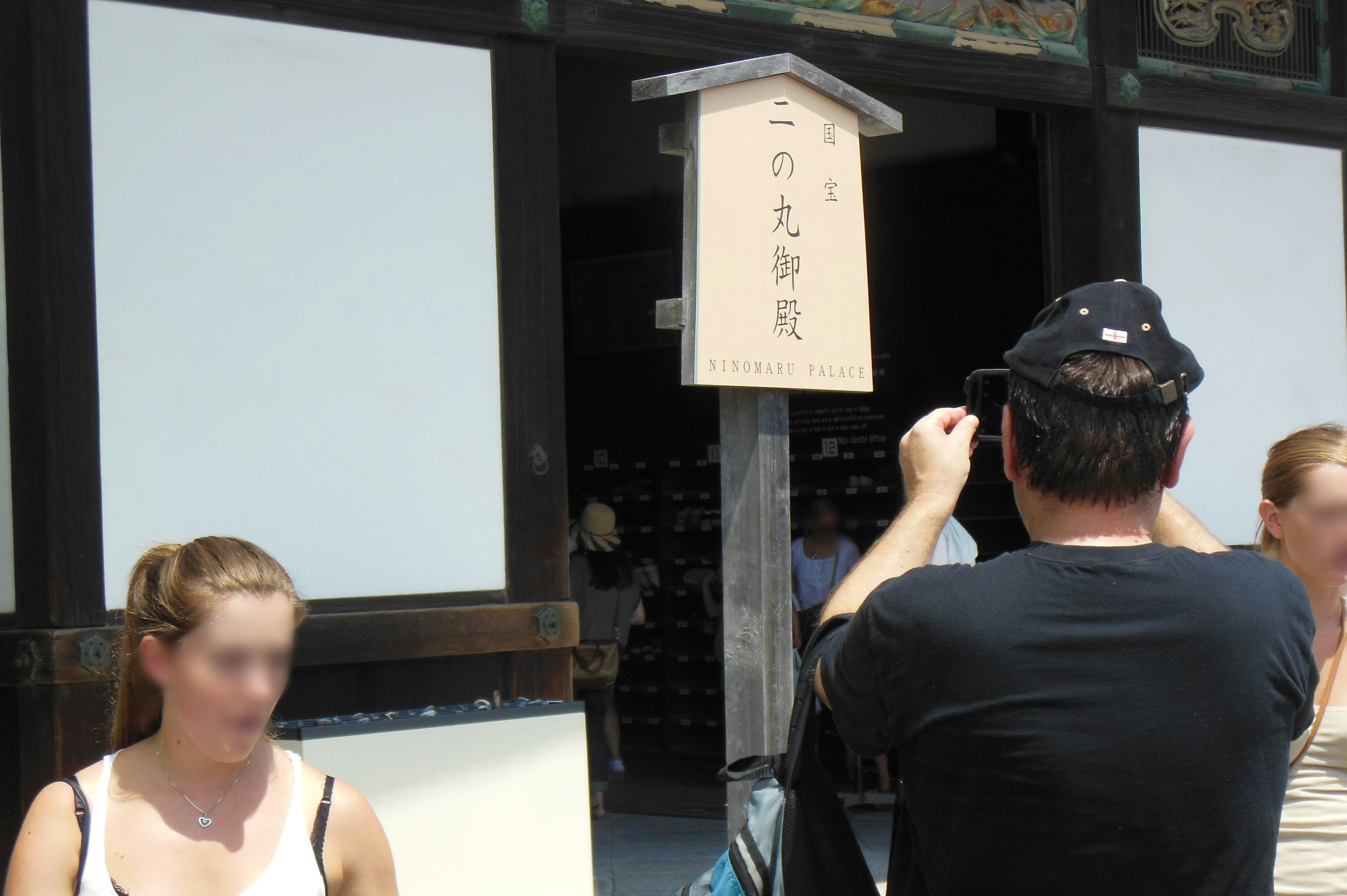 Tourist fotografiert ein Schild vor einem Gebäude