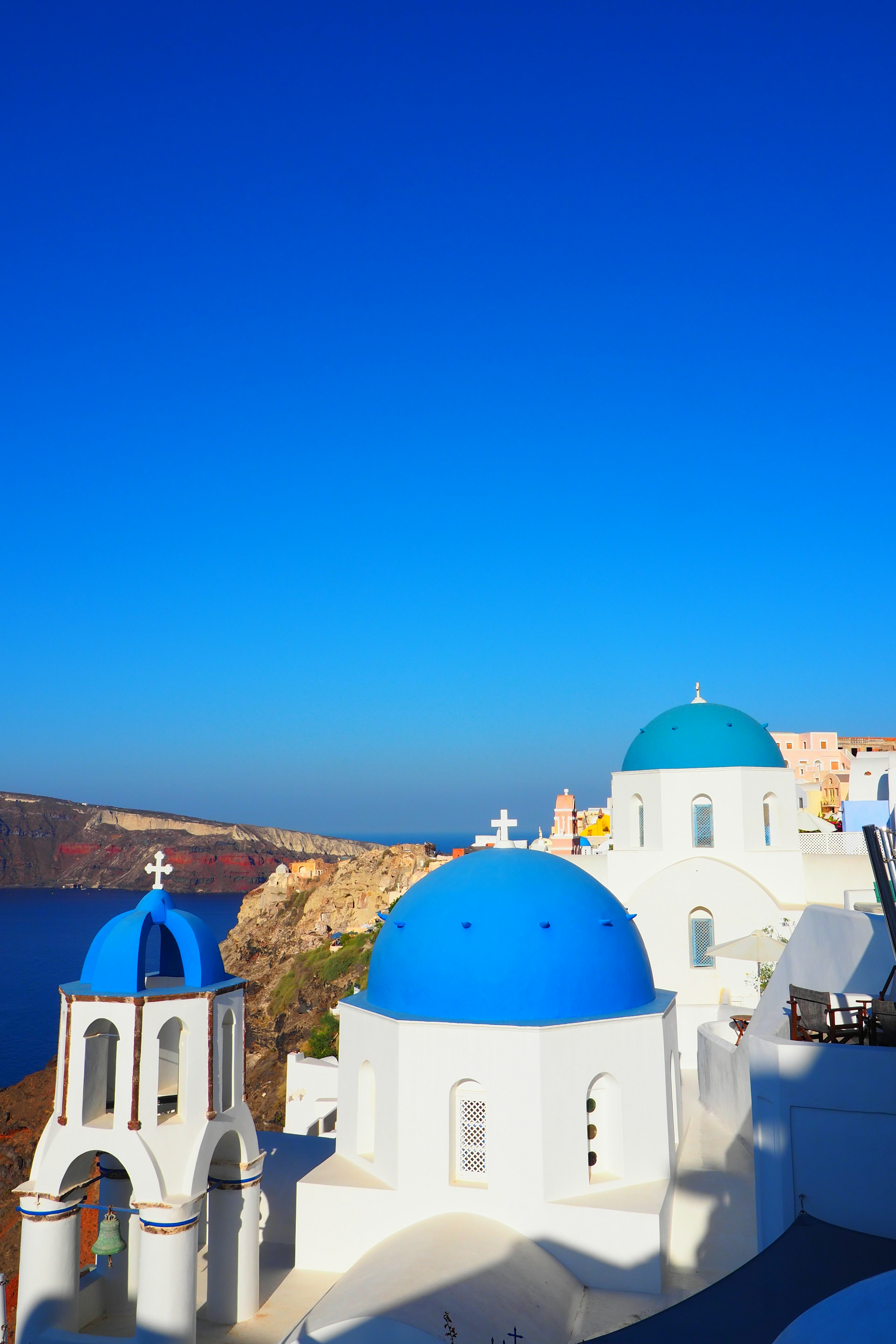 Paysage de Santorin avec des bâtiments blancs et des églises à dôme bleu