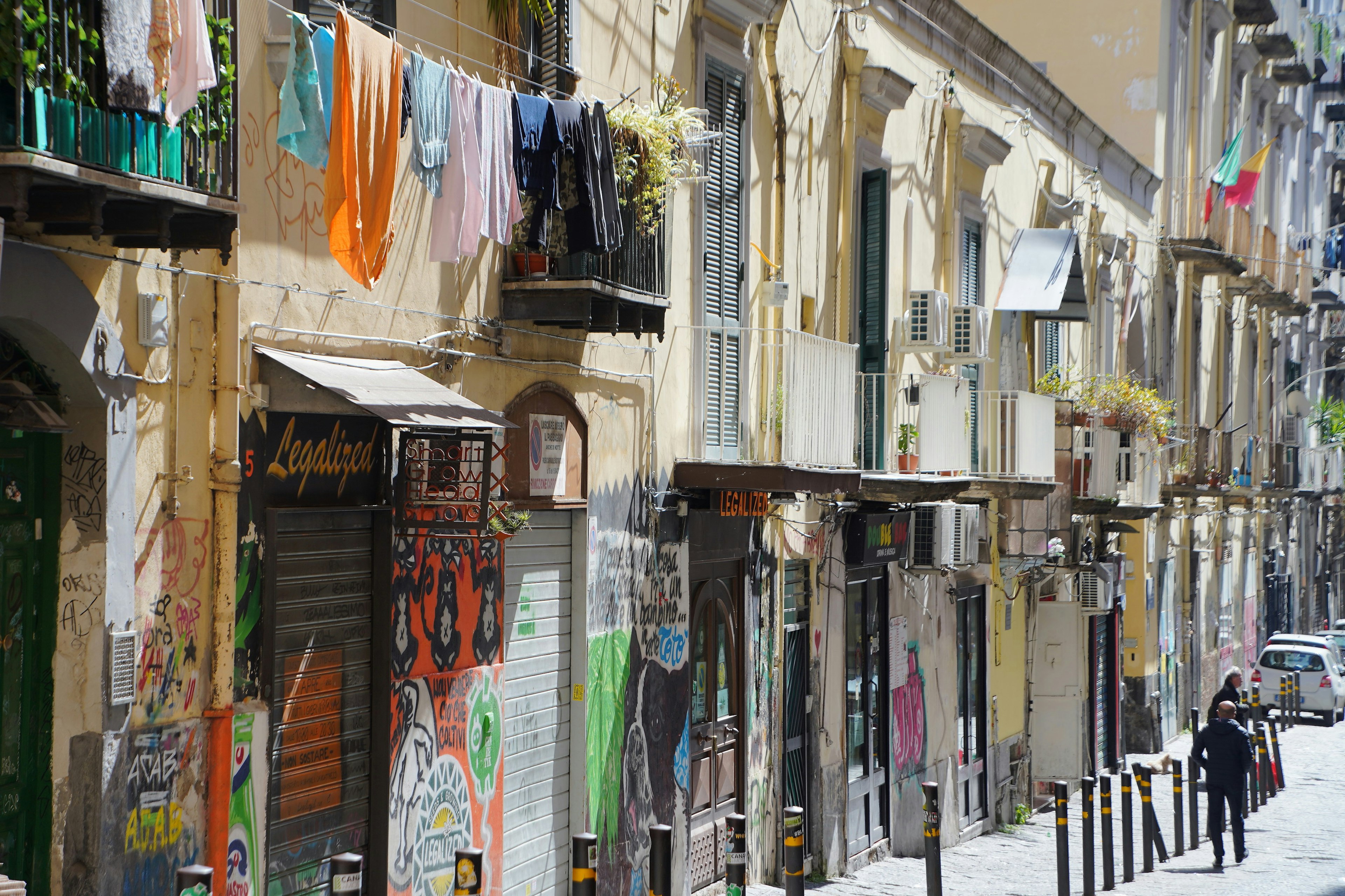 Colorful laundry hanging in an old street with graffiti