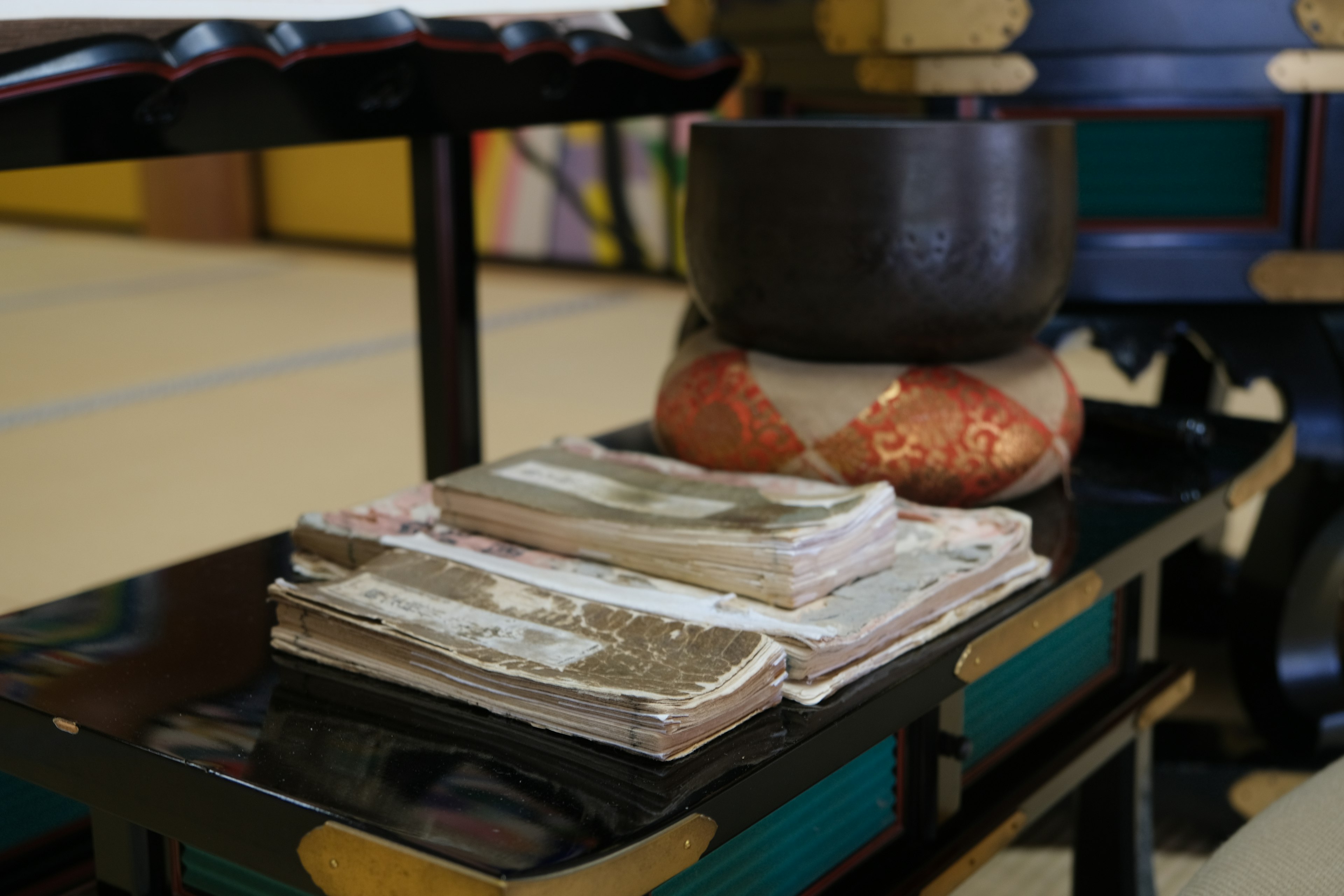 Stack of traditional currency on a decorative table with bowls