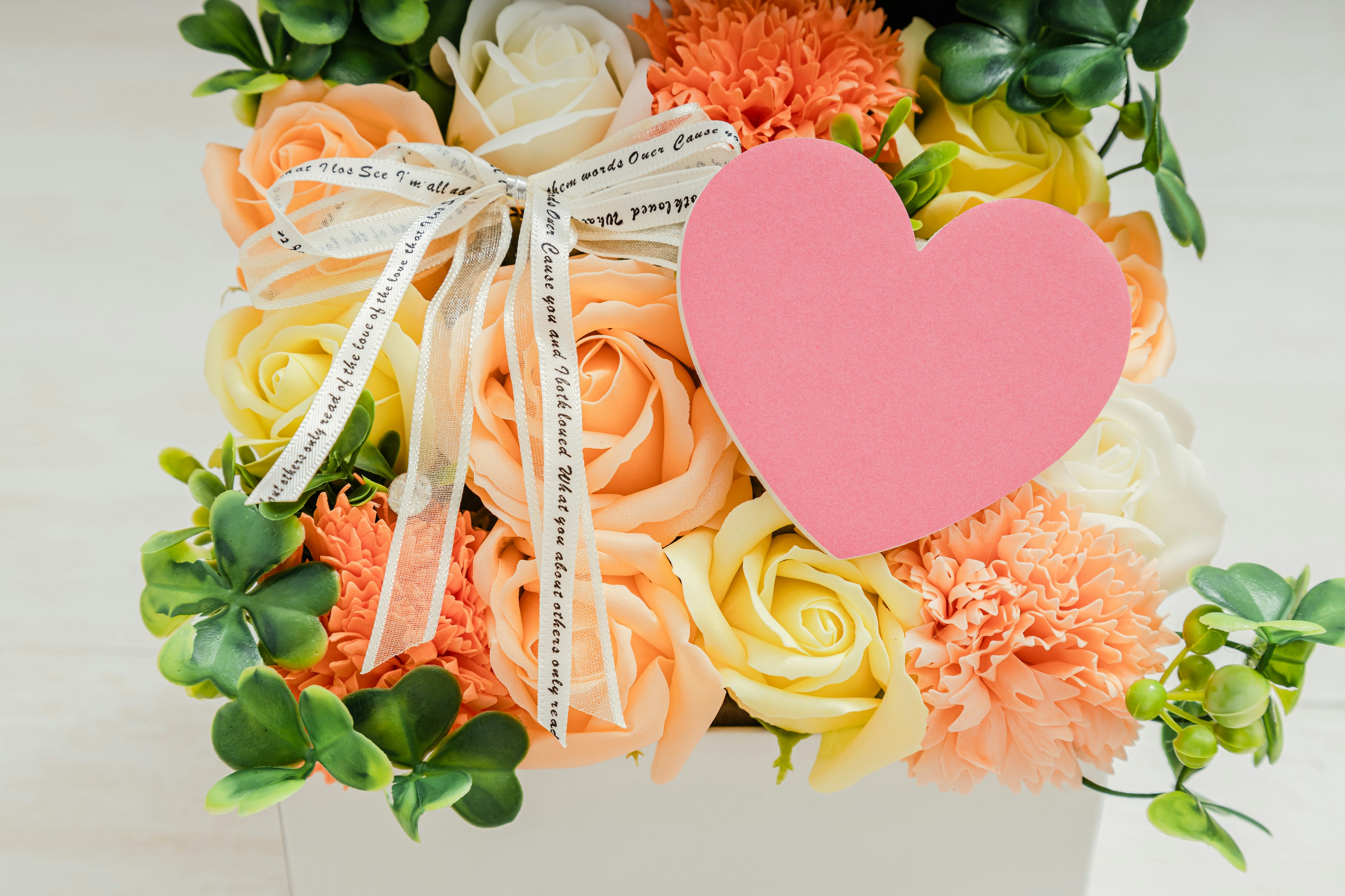 Colorful bouquet with pink heart-shaped card and decorative ribbon