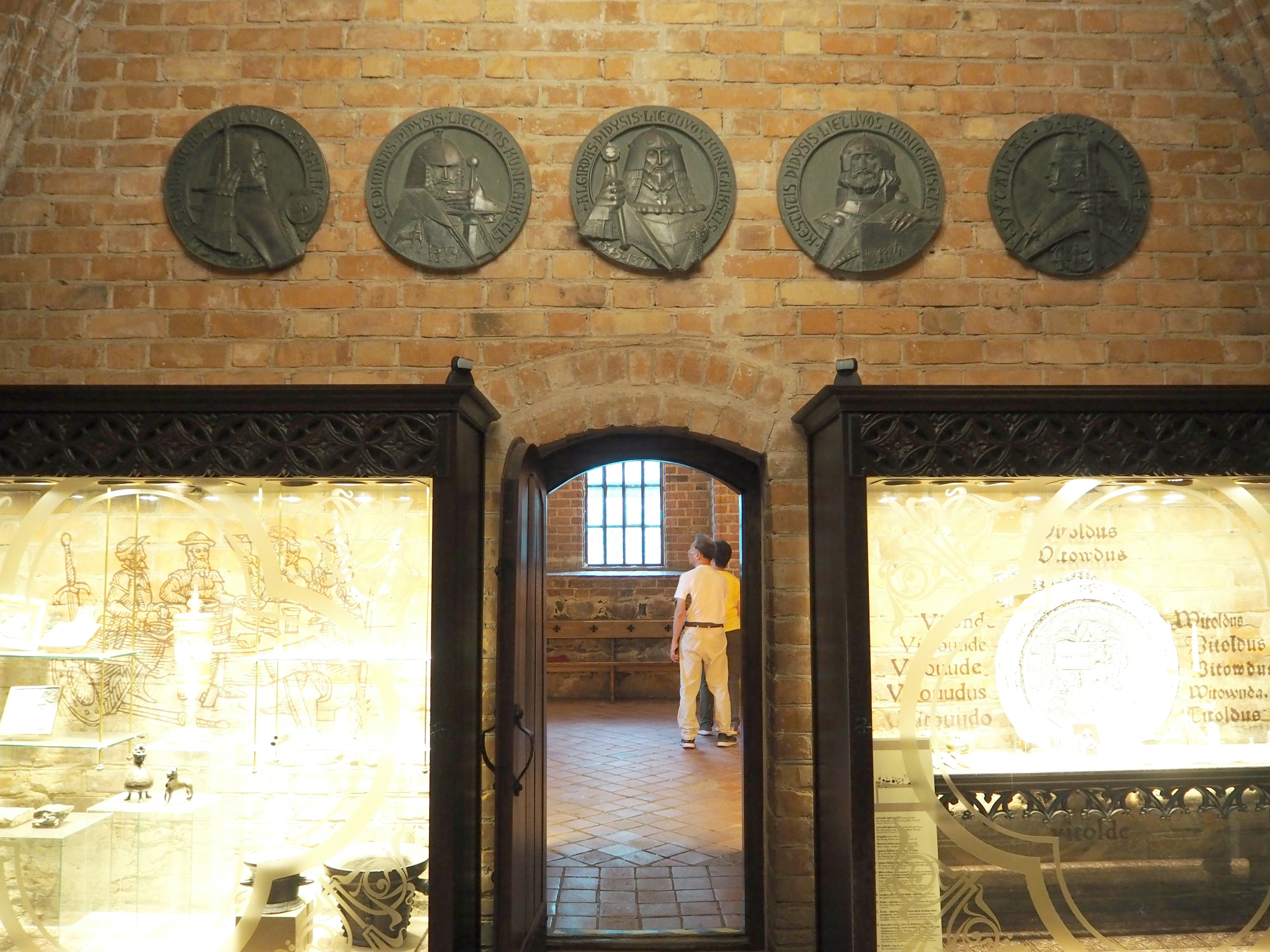 Interior view of a museum featuring historical sculptures on the wall