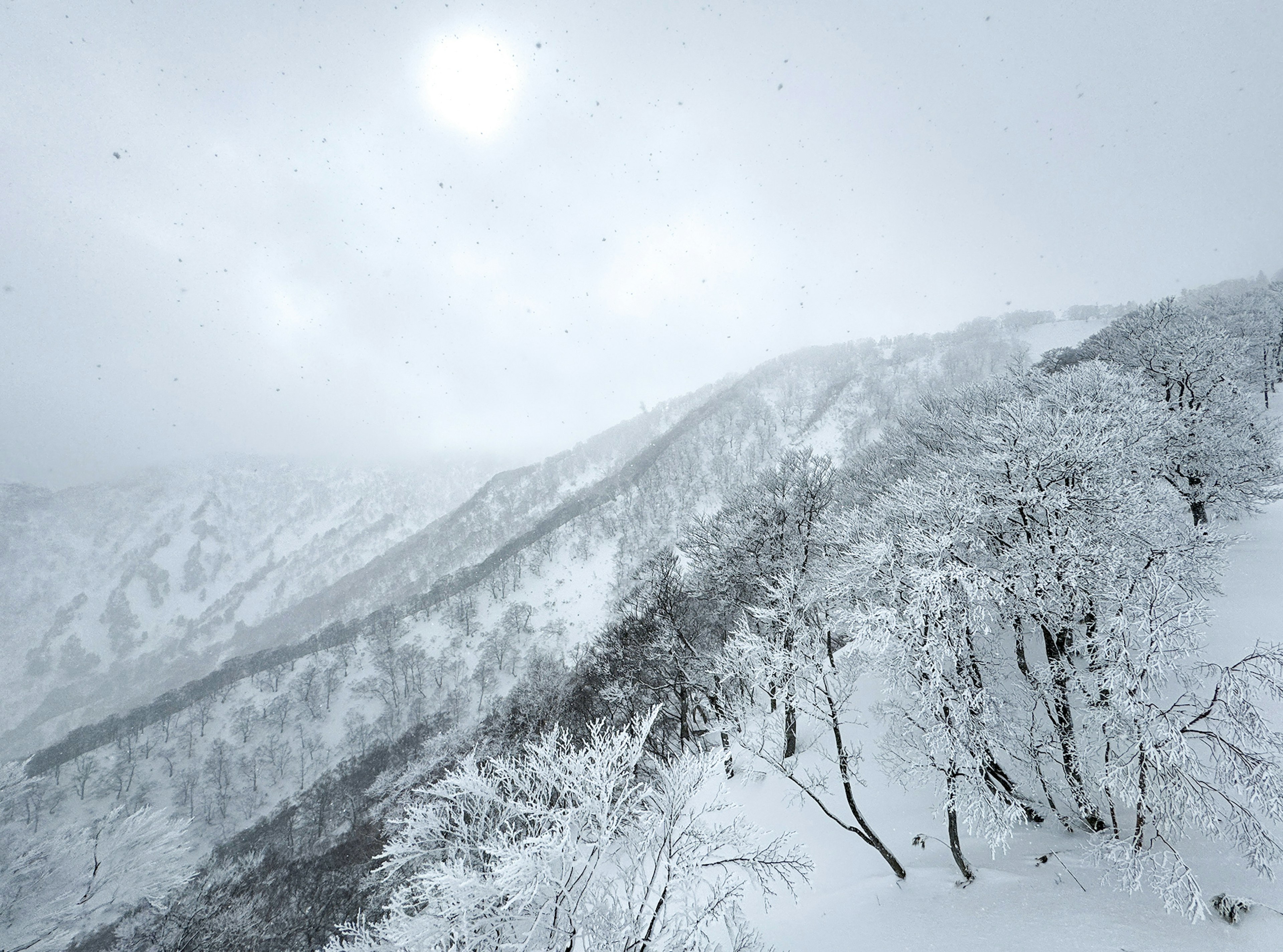 Snow-covered mountain landscape with overcast sky