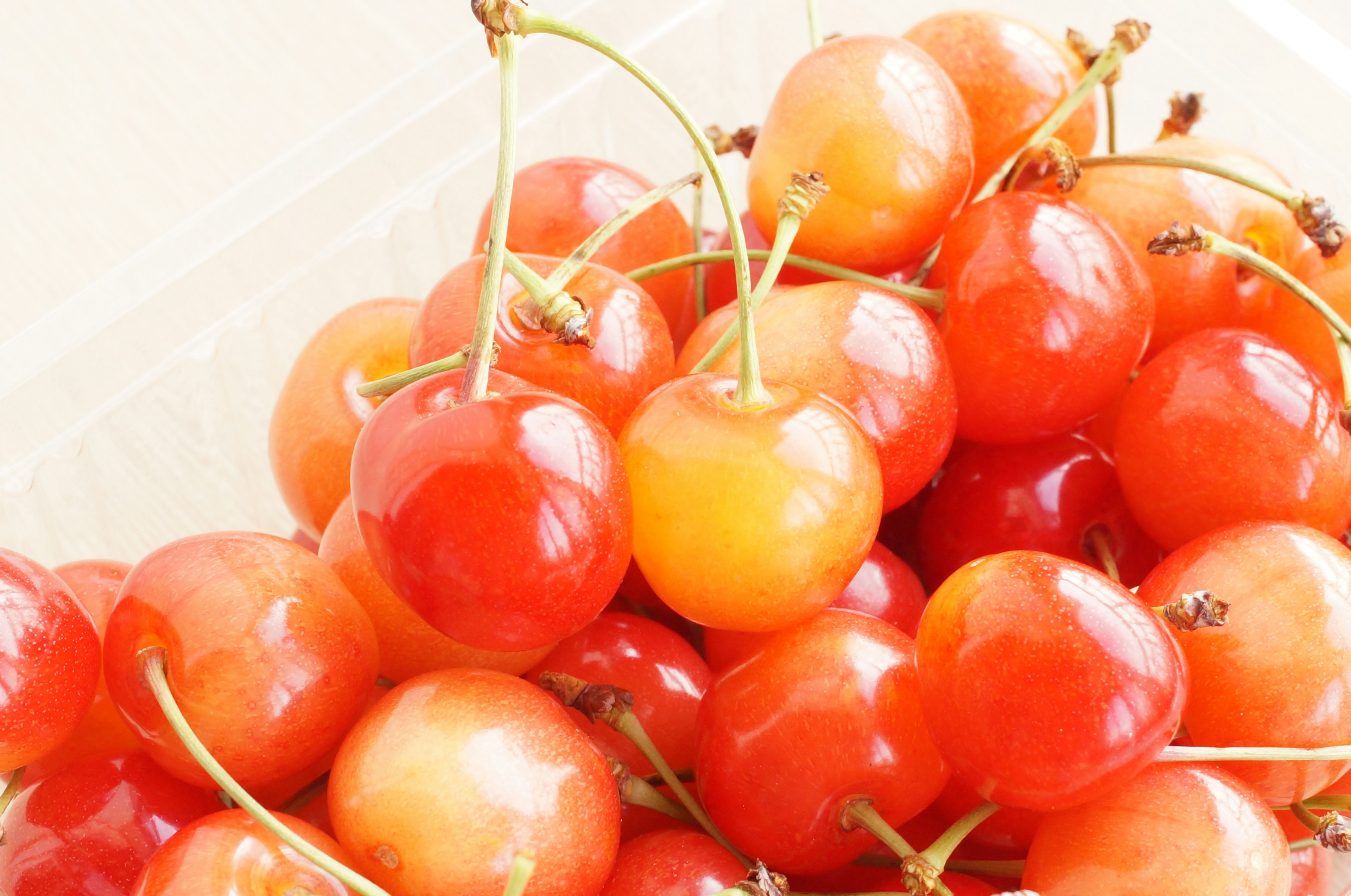 A cluster of bright red and orange cherries