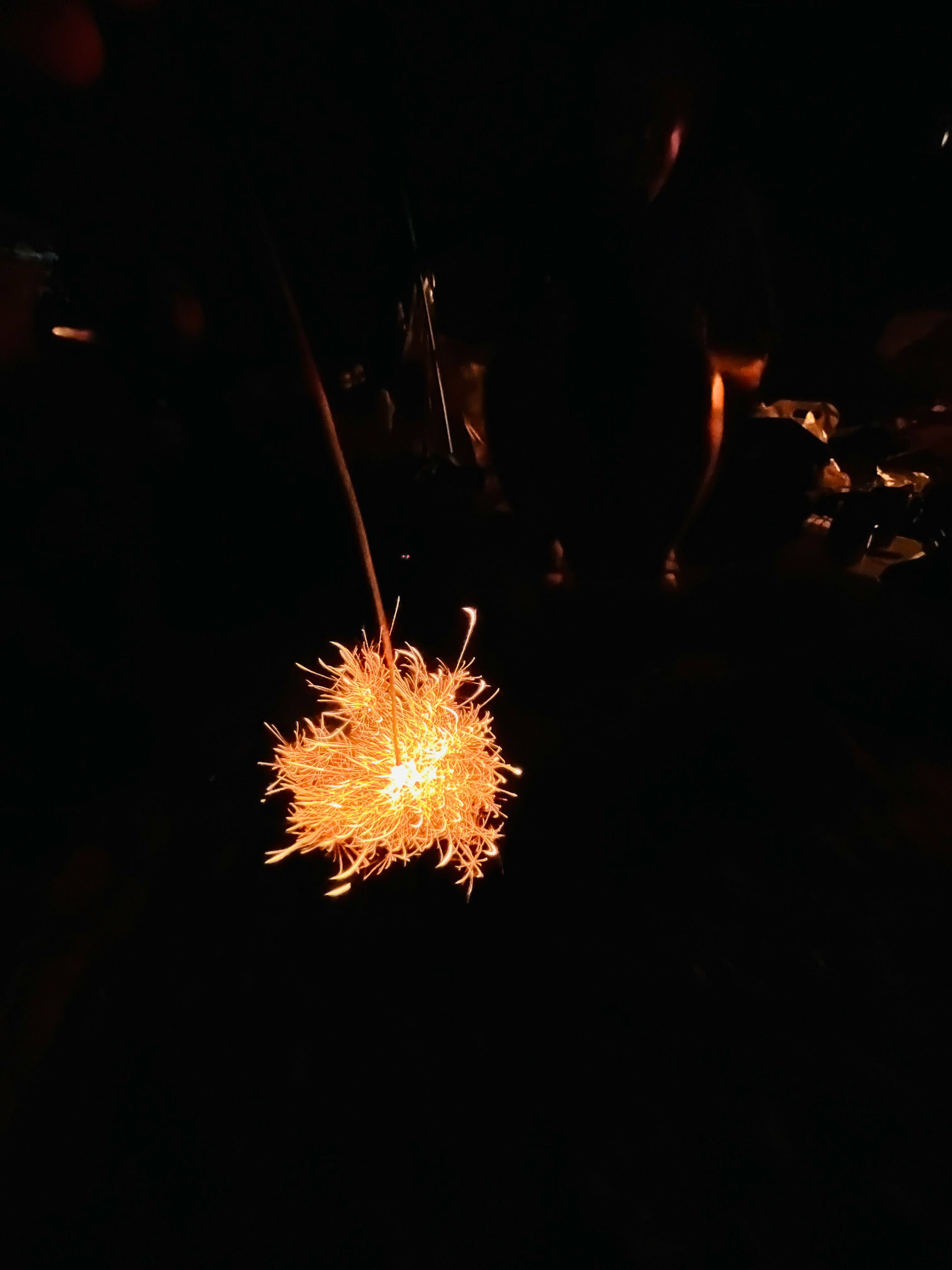 Glowing firework-like object against a dark background