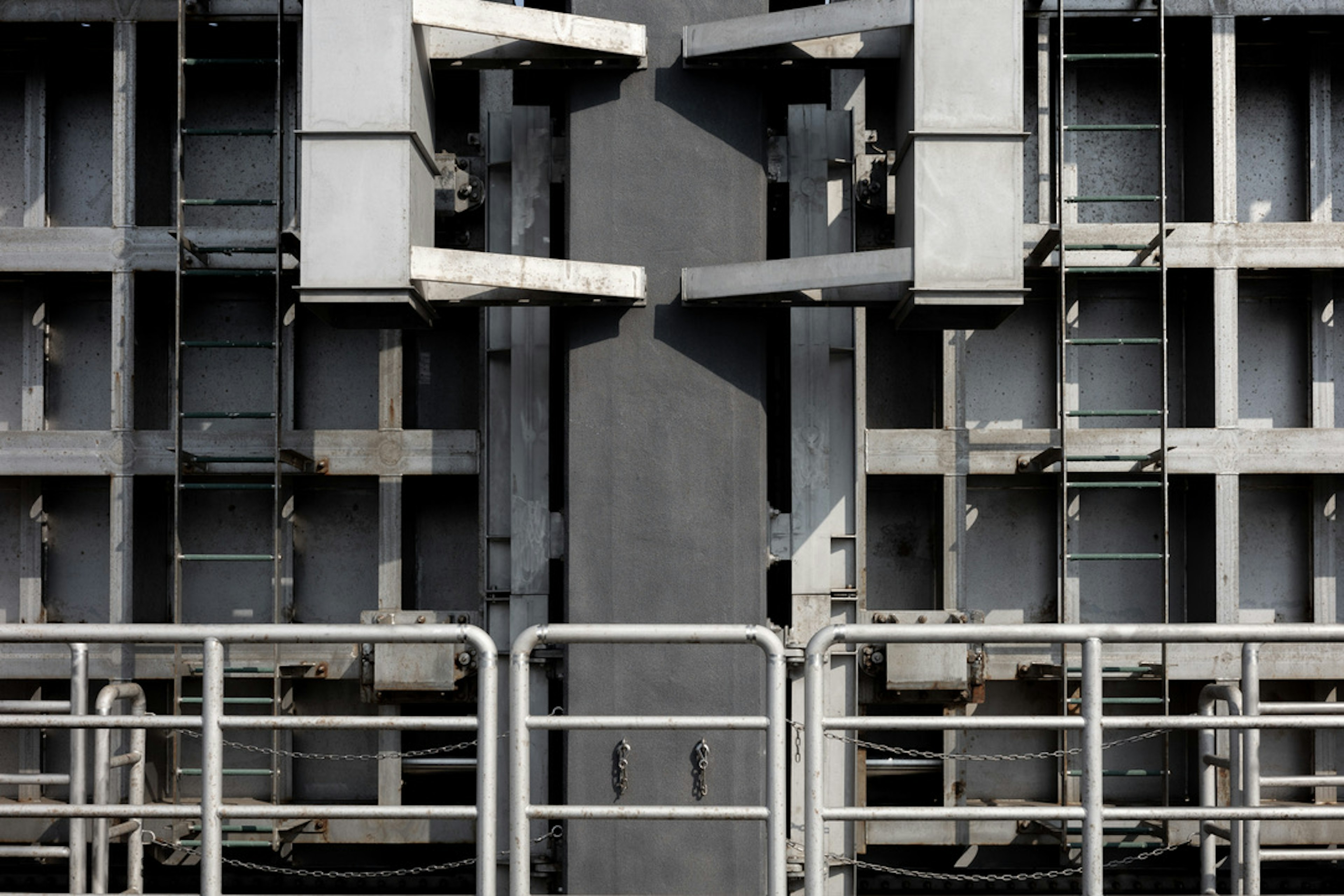 Close-up of a metallic structure featuring multiple components against a gray background