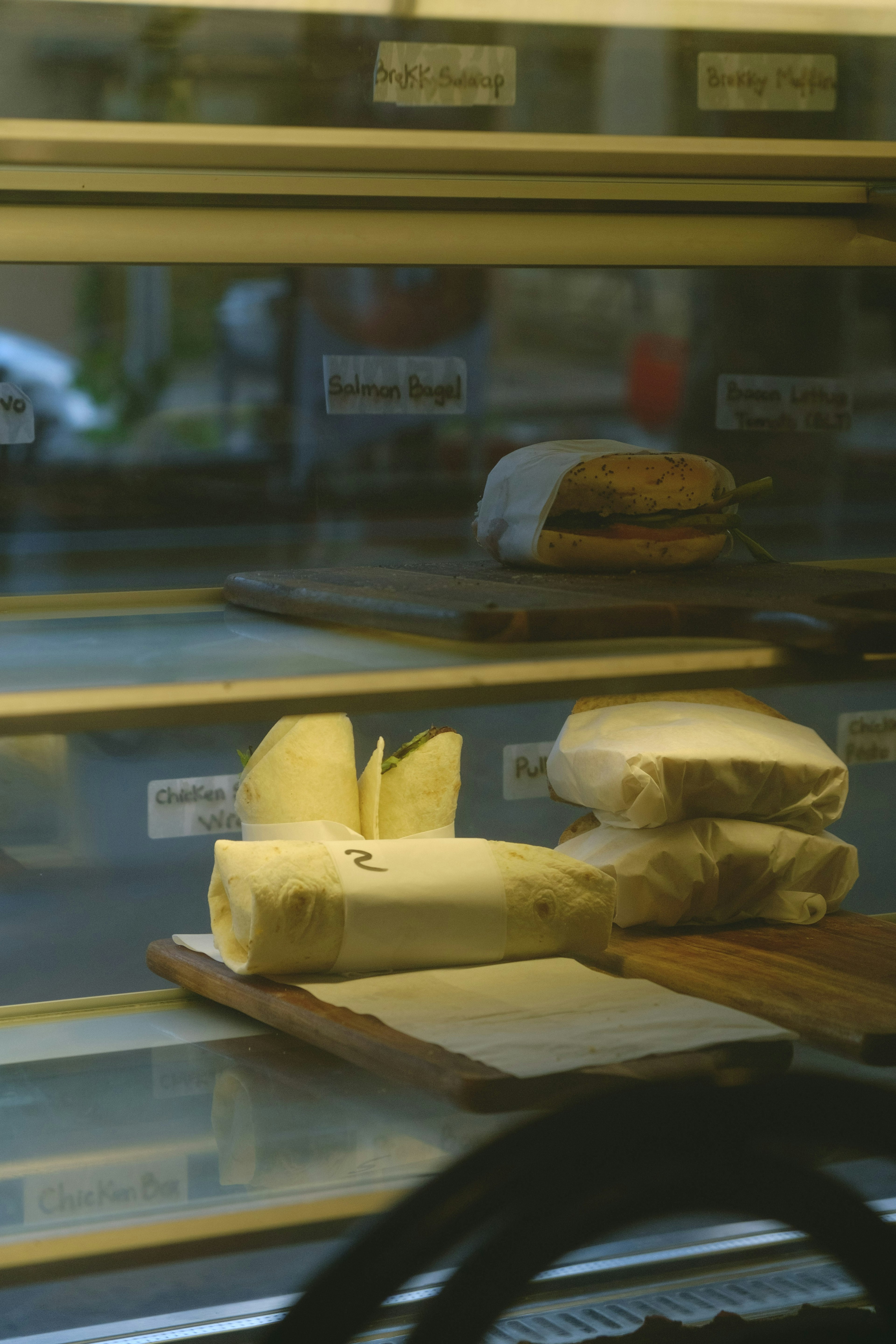 Interior photo of a display case featuring various cheeses