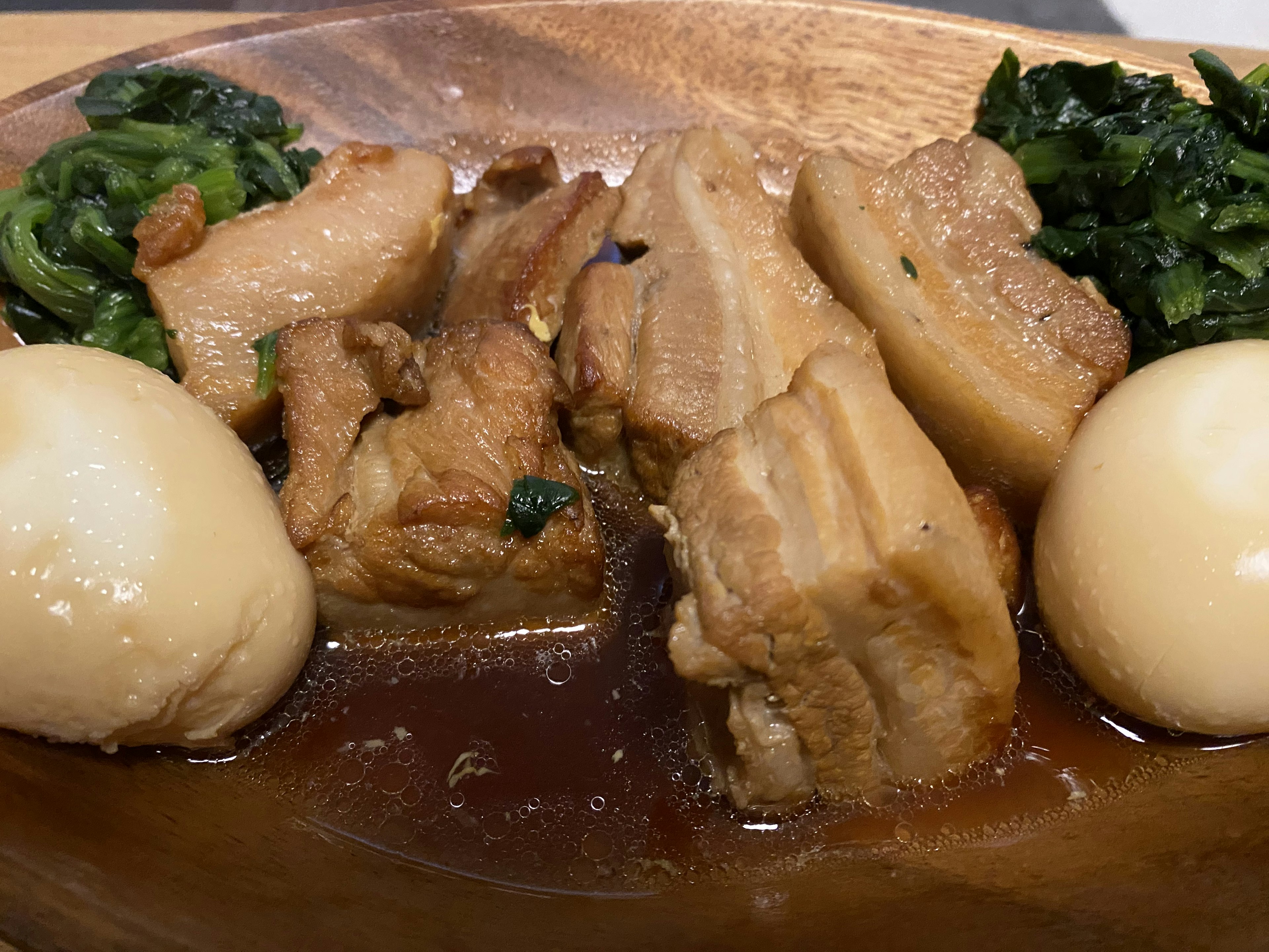 Braised pork belly with boiled eggs and greens