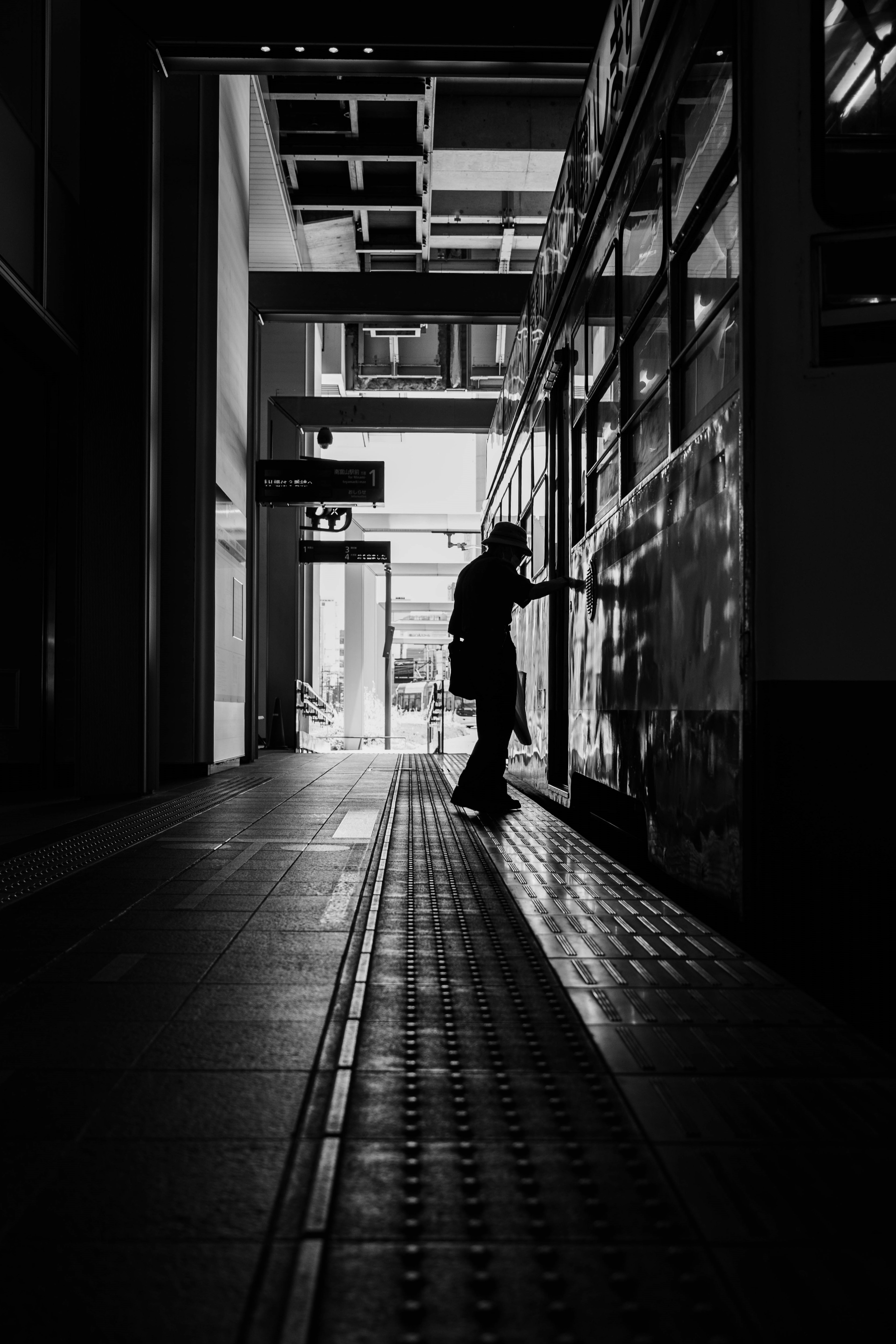 Silhouette of a person working in shadows with a bright background contrast