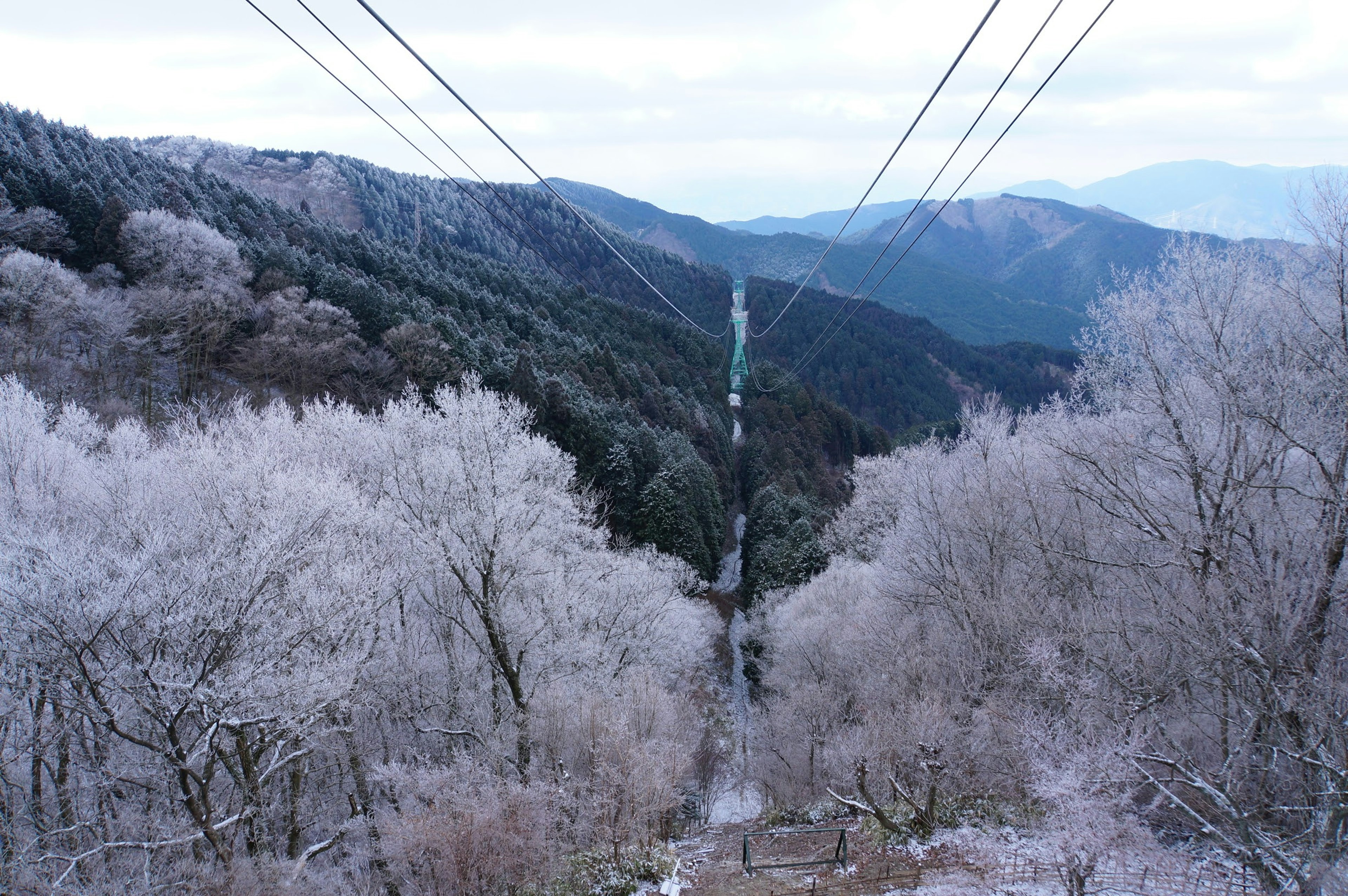 Winter mountain landscape featuring power lines in a serene setting