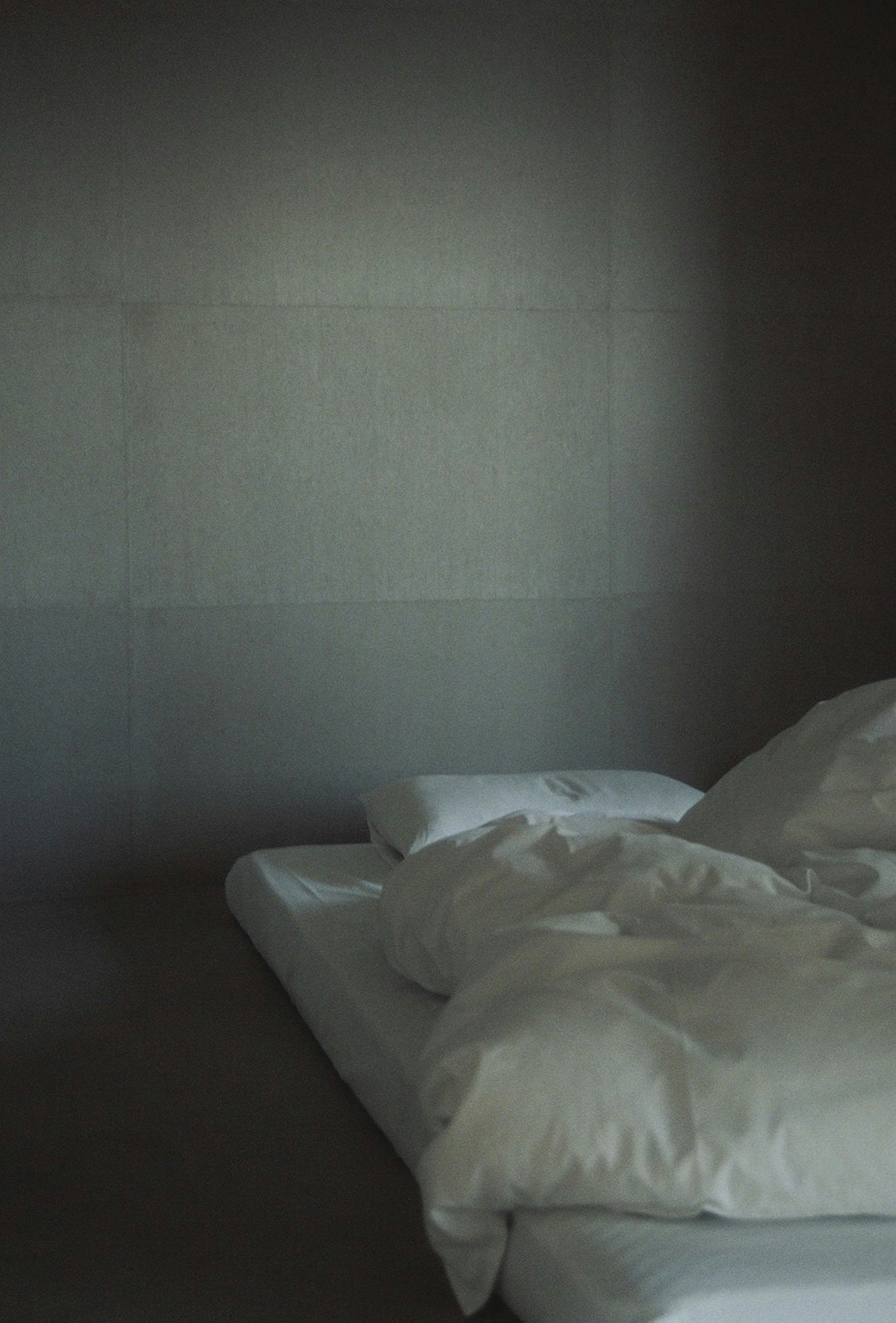 Calm bedroom scene with a simple bed and white bedding