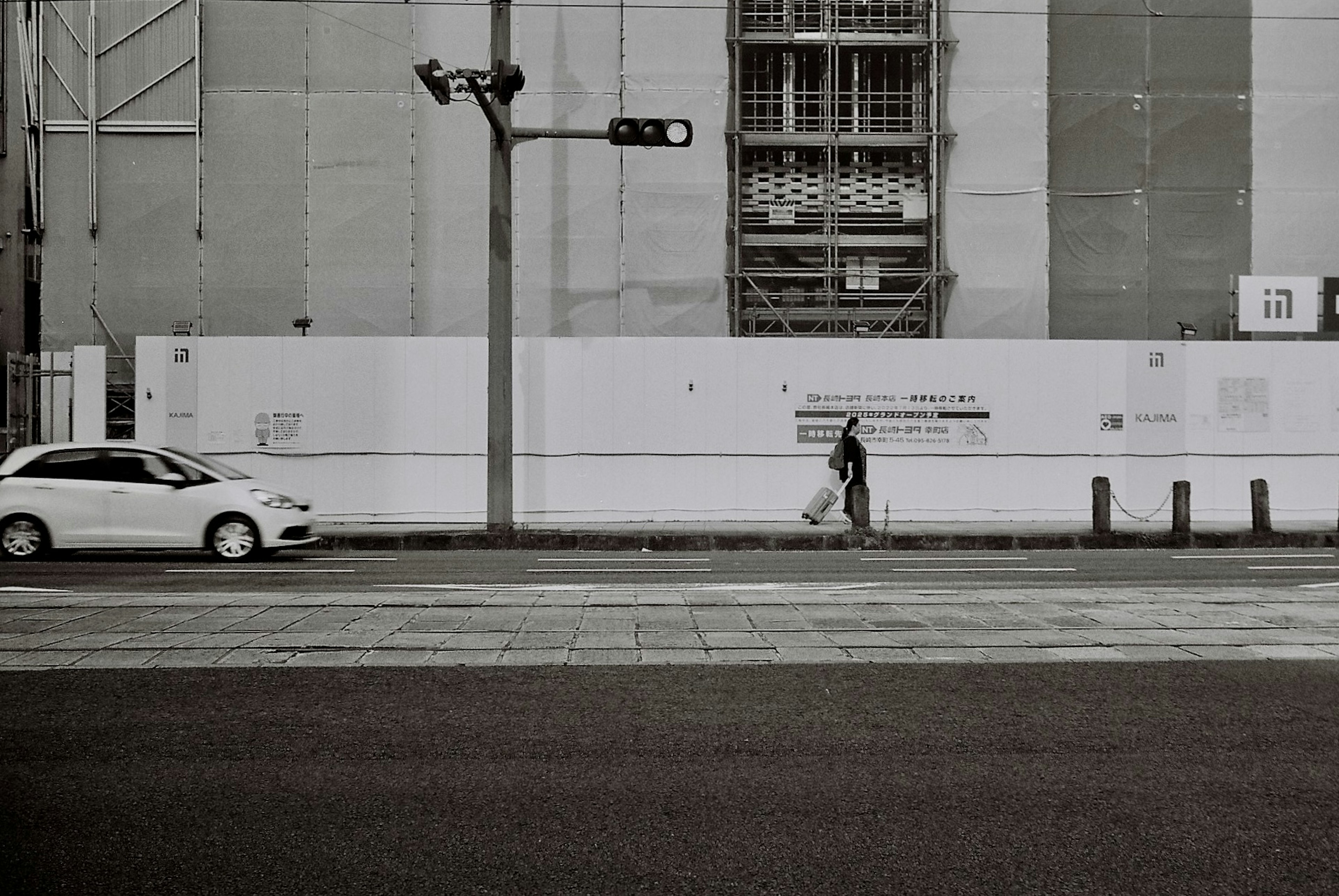 Urban scene with a white car and a pedestrian