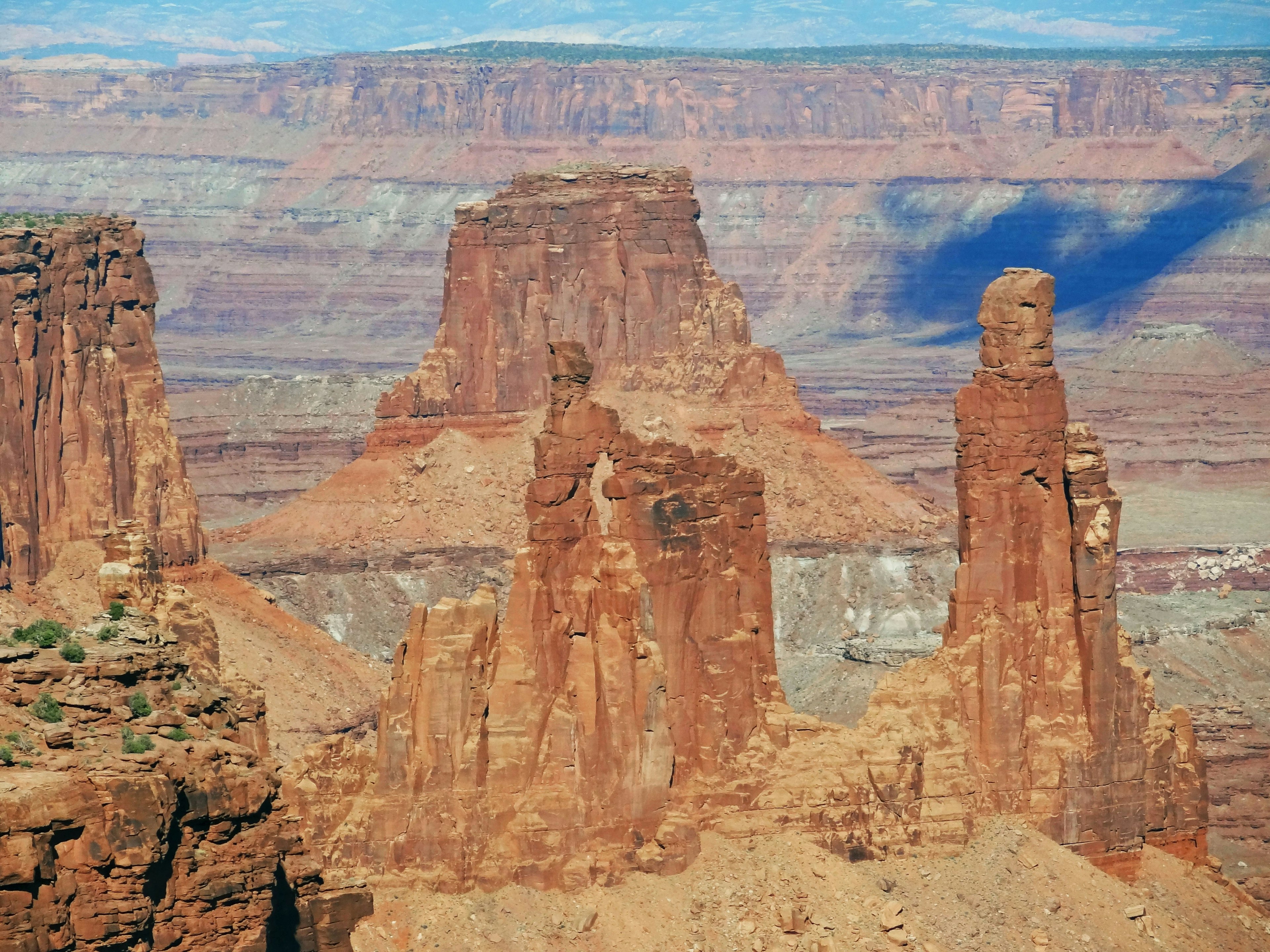 Natural landscape featuring red rock formations and a vast view