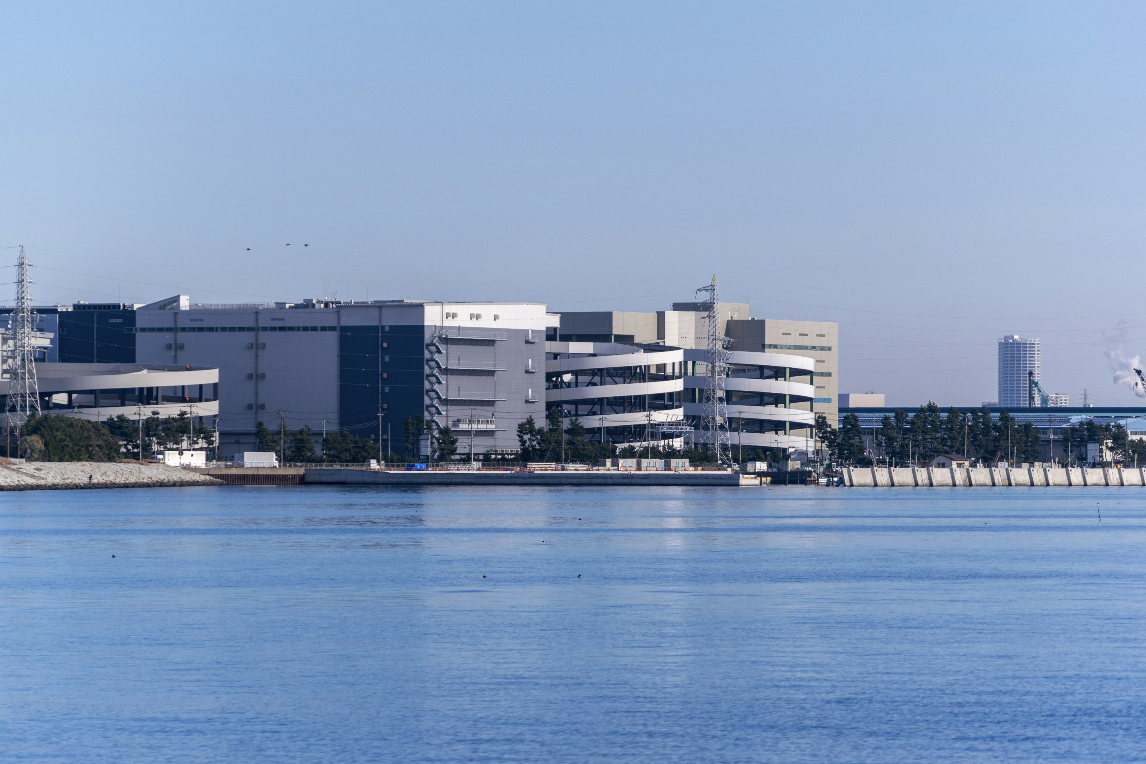 Modern buildings along the waterfront with a calm water surface