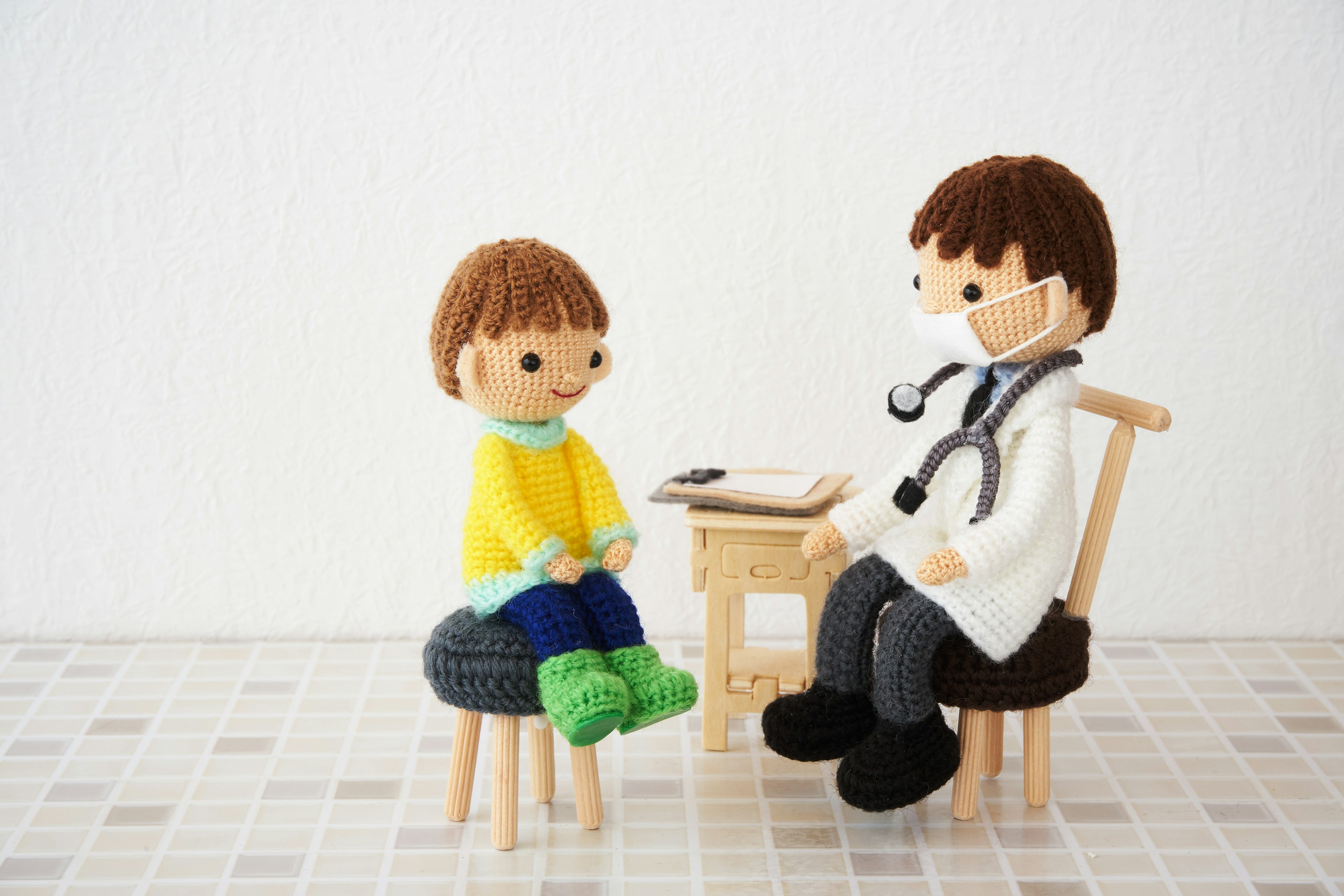 A child and a doctor doll sitting together