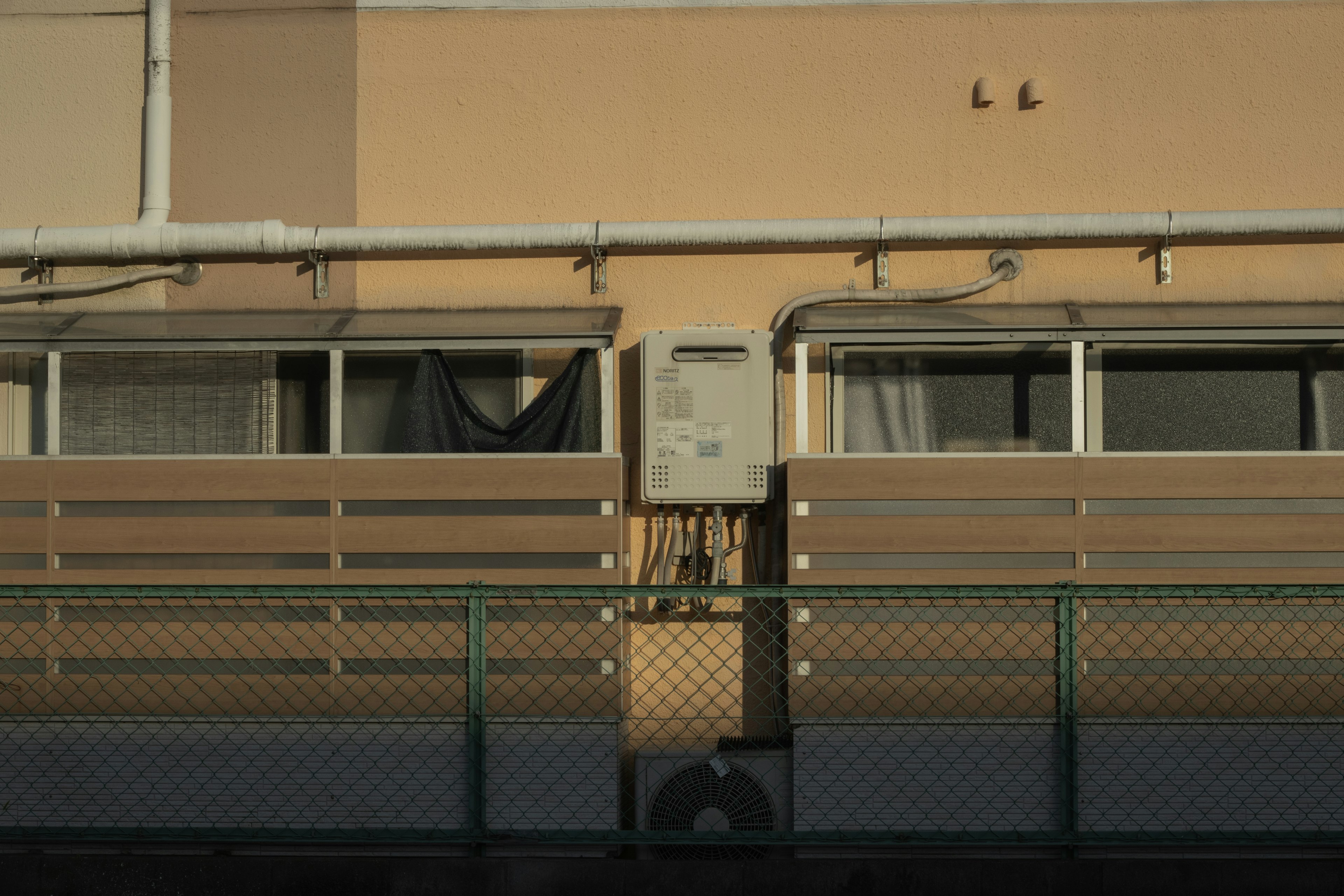 Exterior view of a building with windows and a fence