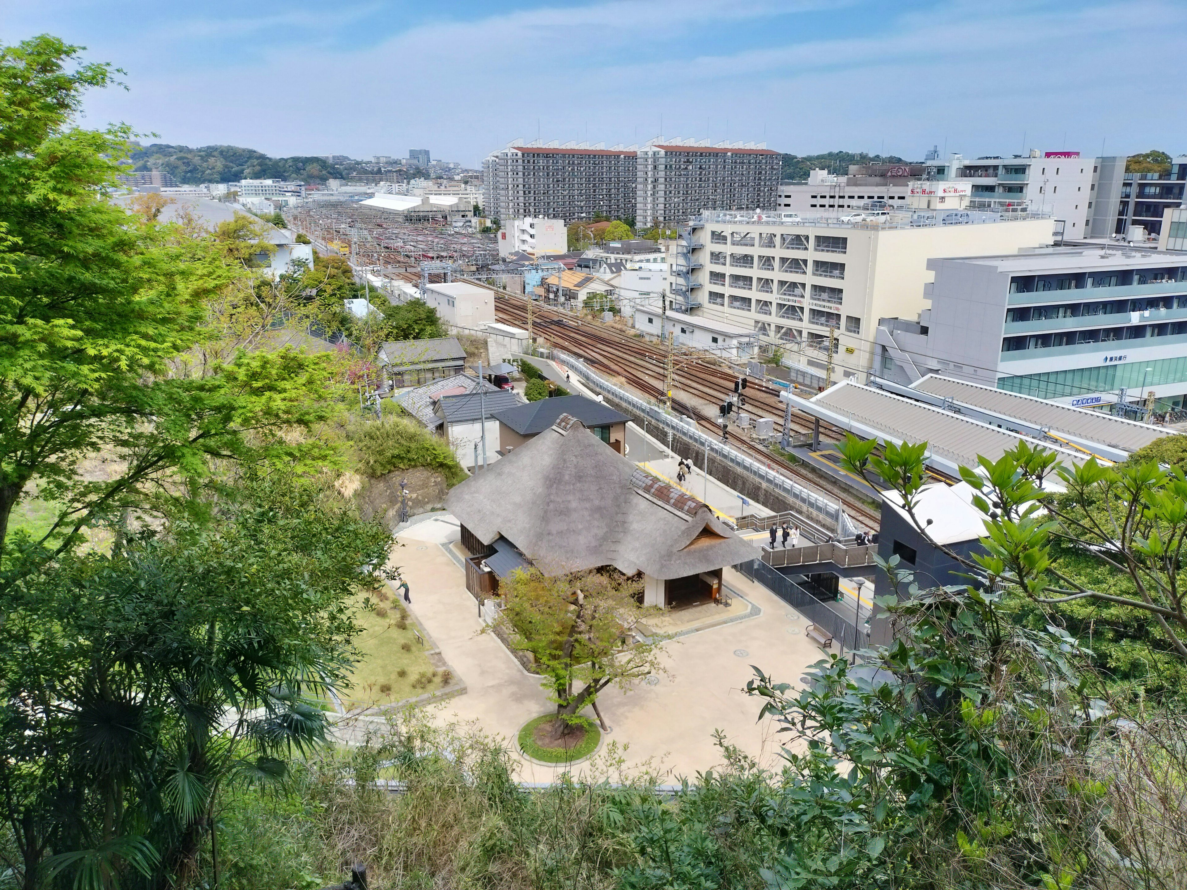 Pemandangan kota dengan taman rimbun dan bangunan tradisional Jepang