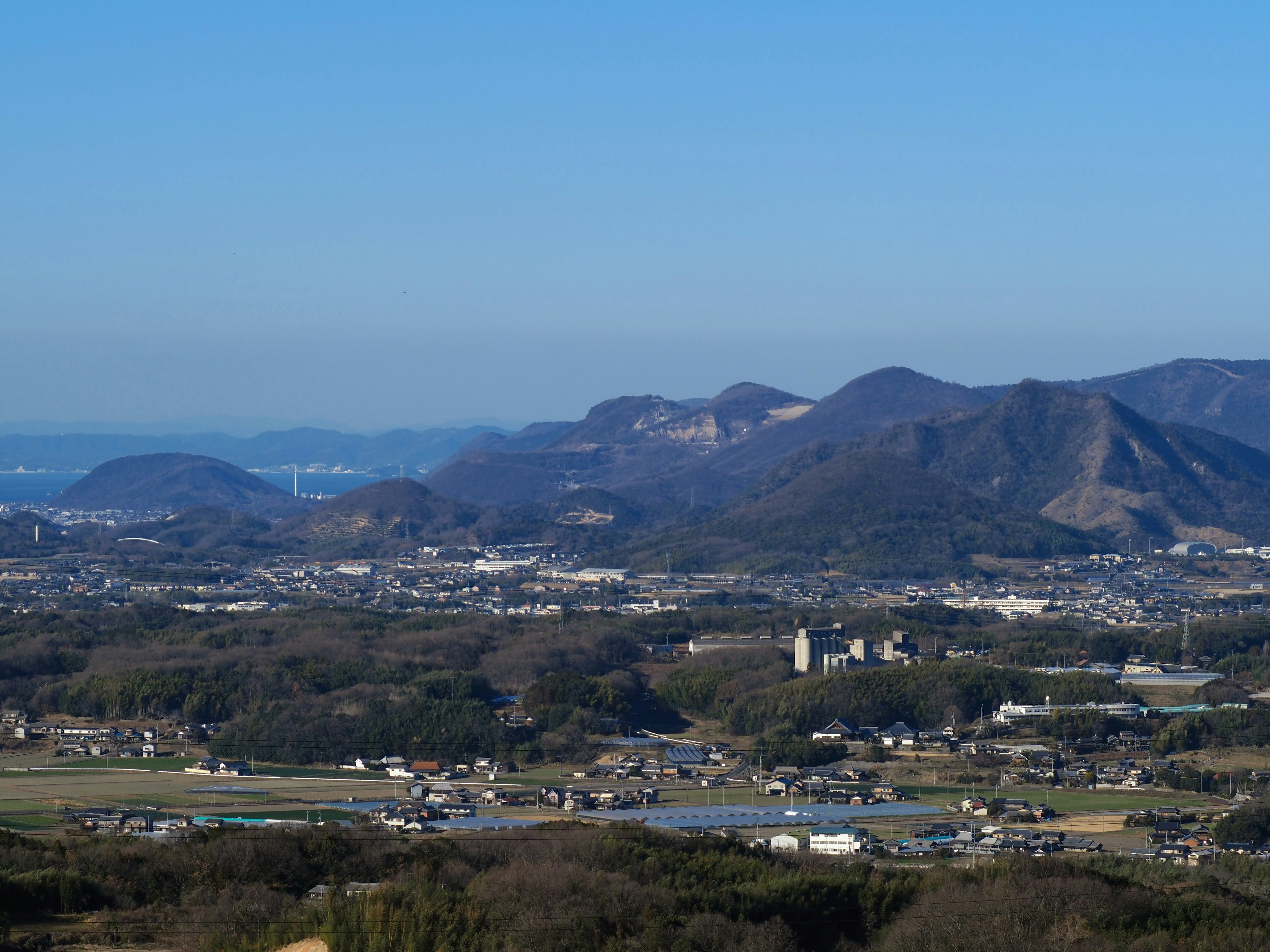 Scenic view of mountains and plains under a clear blue sky